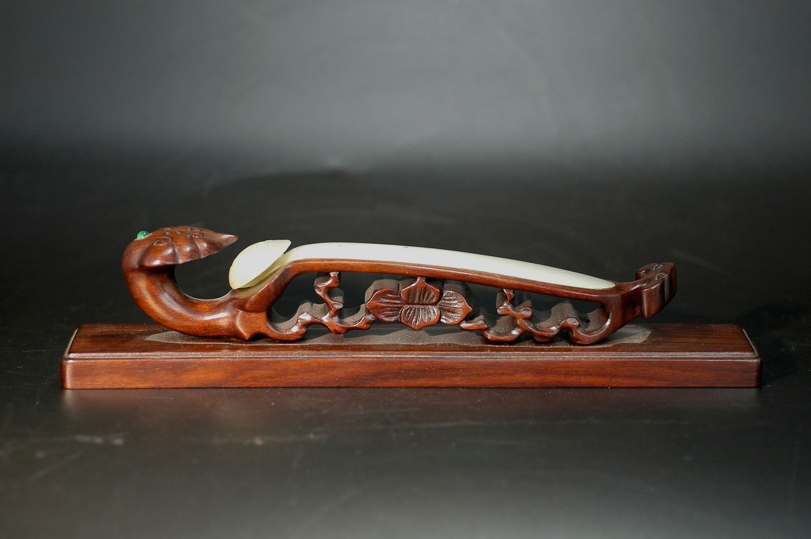 Qing Dynasty Greenish-White Jade Ruyi-Head Hairpin with Rosewood Stand: H:13cm W:3cm. Qing Dynasty Celadon White Jade Ruyi-Head Hairpin (with Rosewood Base). Core Information - Material: Main body of Hetian celadon white jade, with rosewood (or red sandalwood) inlaid seat