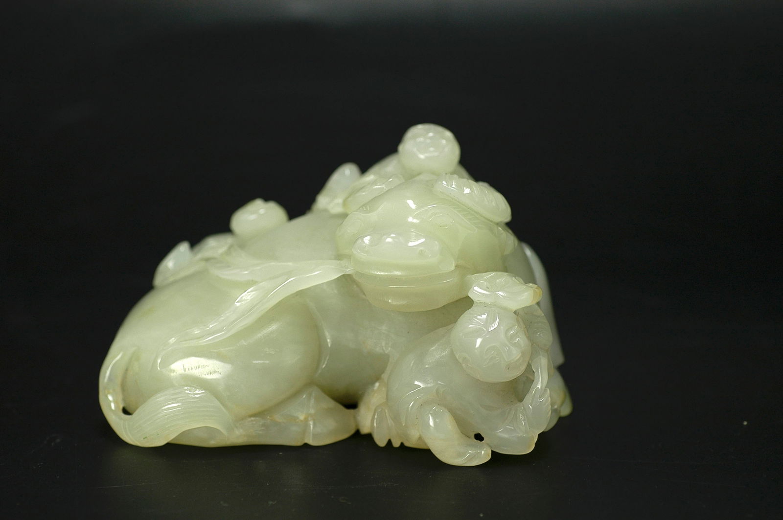Hetian Greenish-White Jade Boy Playing with Buffalo: H:5.2cm W:9cm. Mid-Qing Period (Qianlong-Jiaqing) Hetian Celadon White Jade Boy Playing with Ox Figure (Five Sons Achieving Success/Boy Herding Ox). Attribution: Mid-Qing Dynasty (Qianlong to Jiaqing)