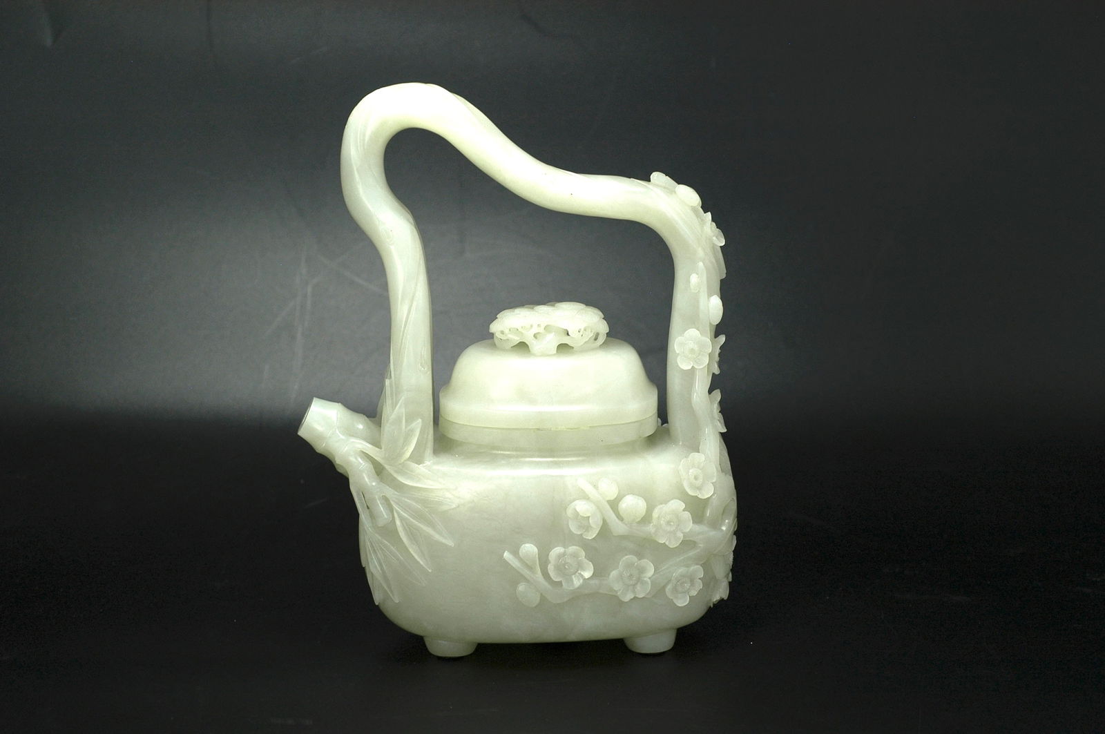 Qing Dynasty Hetian Jade Prunus Bail-Handle Pot with Pine Needle Lid: H:22cm W:16cm Item: Mid Qing Dynasty Celadon-White Jade Teapot with Plum and Bamboo Handle. Period: Mid Qing Dynasty (18th–19th century). Material: Celadon-white jade, warm and lustrous in textu