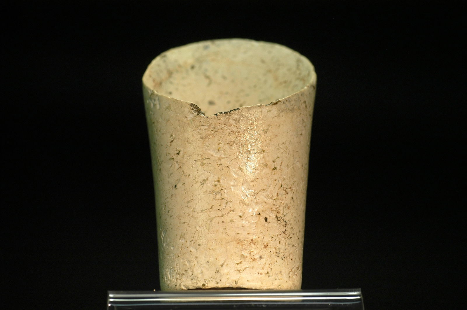 Hongshan Culture Chicken-Bone White Jade Horse-Hoof Form Cylindrical Vessel: H:8.6cm W:5.3cm. Object Designation: Neolithic Period, Hongshan Culture — Tremolite jade slanted-rim cylindrical object with 'chicken-bone white' alteration (horseshoe-form or jade hoop-type ves