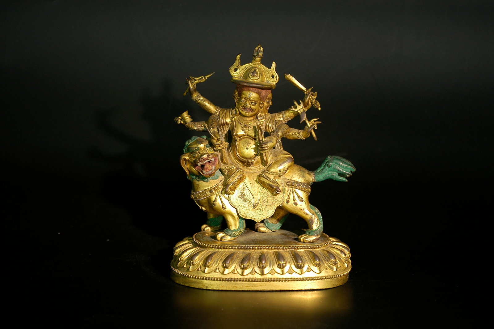 Qing Mid-Period Gilt Bronze Three-Headed Six-Armed White Jambhala Figure: H:19cm W:13cm Period: Mid-Qing Dynasty (18th-19th century). Material: Gilt bronze with partial mineral pigment and gold decoration. Subject: Three-headed, six-armed White Jambhala riding green-maned l