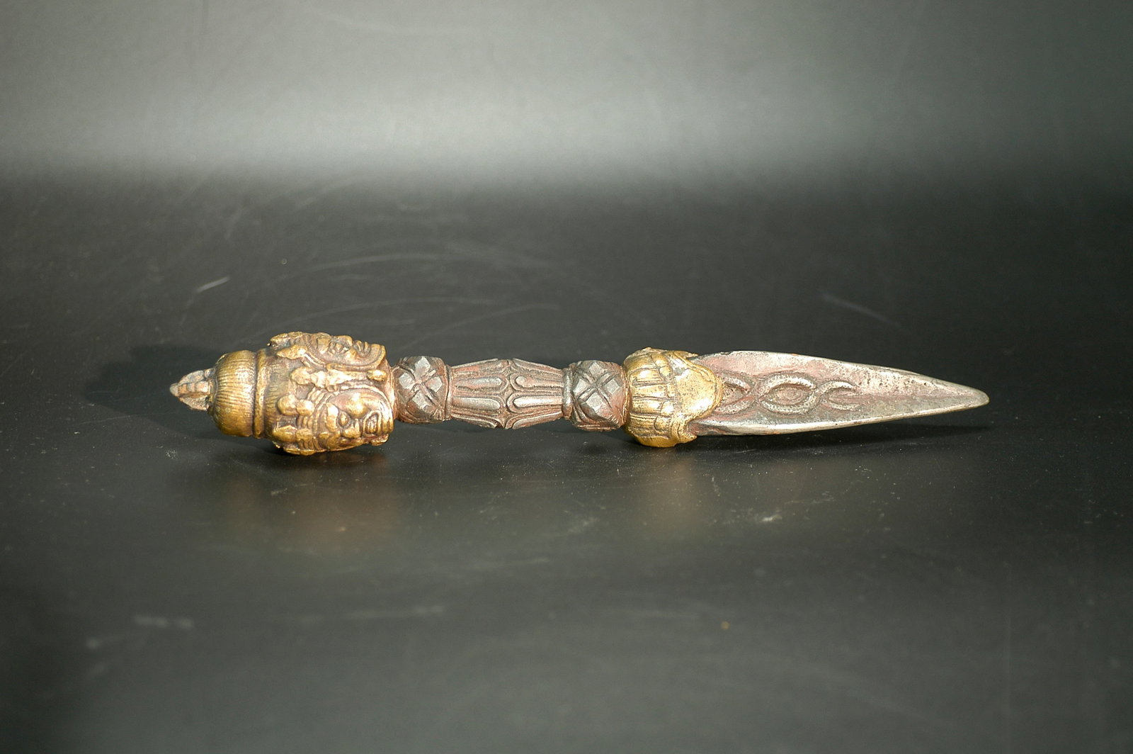 Qing Dynasty Gilt Bronze Three-Faced Phurba Vajra: H24.2cm W3.5cm. Object Designation: Mid Qing Dynasty (Qianlong-Jiaqing) Gilt-Bronze Three-Faced Phurba Vajra (Tibetan Buddhist Ritual Implement). Dating Conclusion: Authentic mid Qing Dynasty opening