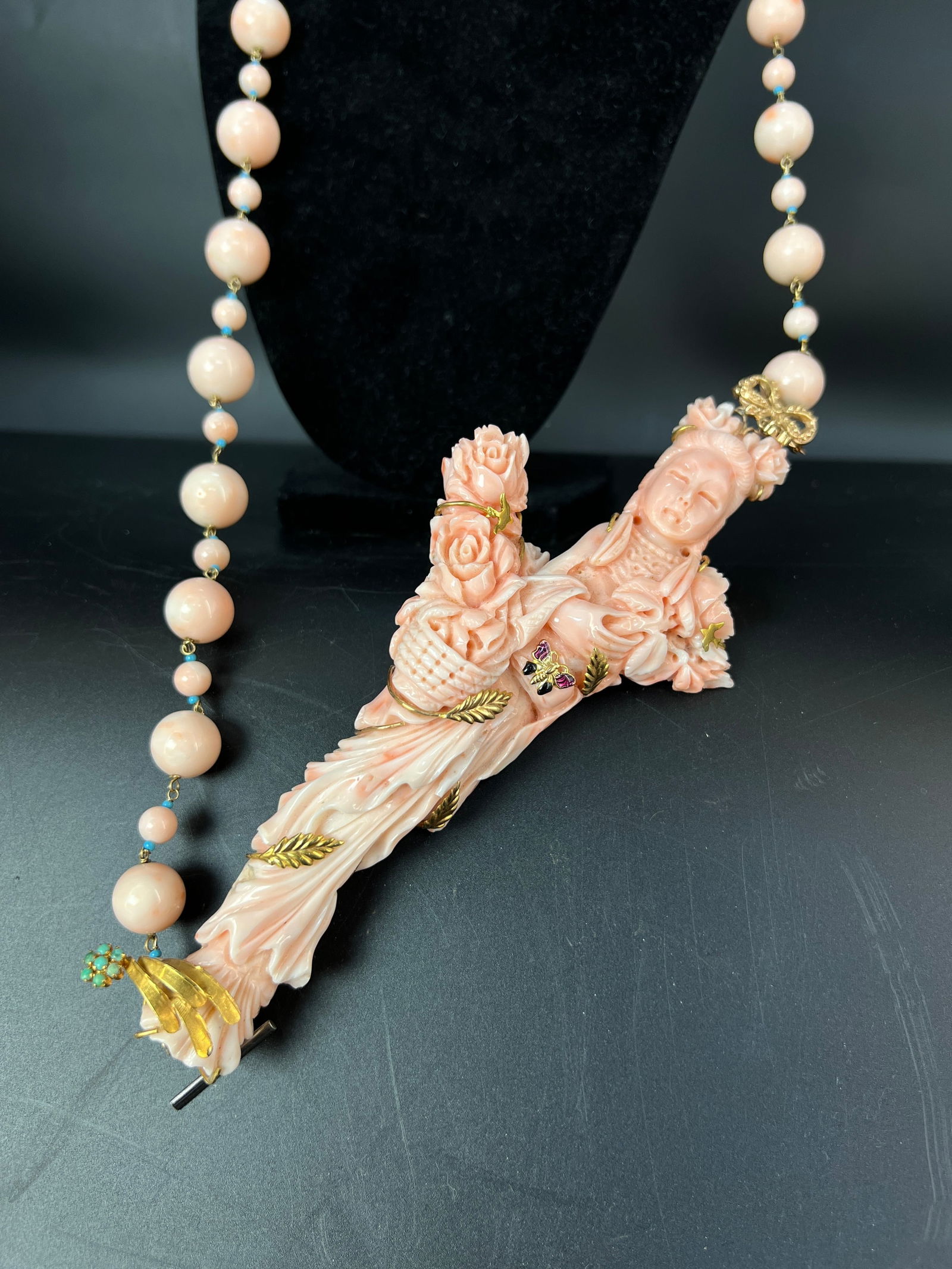 14K Gold Angel Skin Coral Lady with Basket Necklace: Figure H16cm W7.5cm Pearl diameter 1.4cm/0.6cm. 14K Gold Necklace with Angel-Skin Coral Lady Carrying a Basket. Material: Angel-skin (pink) coral, 14K yellow gold, turquoise, and enamel-set