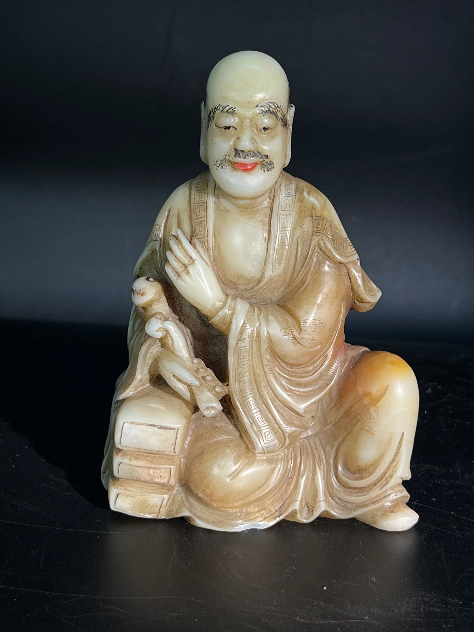 Shoushan Stone Luohan Figure Holding Ruyi Seated Ornament: H12cm W8.5cm Shoushan Stone (White Furong) Figure of an Arhat (Ruyi Arhat). Material: Shoushan stone (white Furong variety), carved in the round with polychrome decoration. Dating: Mid to late Qing Dy