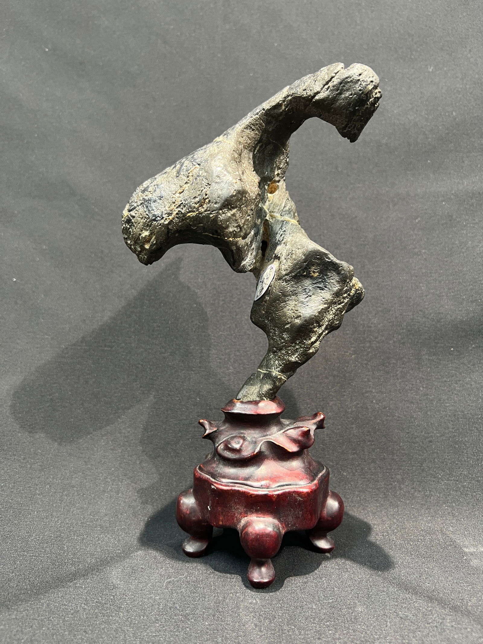 Republic Period Scholar's Display Rock, Lingbi Stone: H22cm W8.5cm (include base) Lingbi Scholar's Rock (Gongshi). Stone Type: Lingbi stone, one of the traditional 'Four Famous Stones.' Base: Old hardwood (hongmu or hongsuanzhi), in Qing to Republic styl