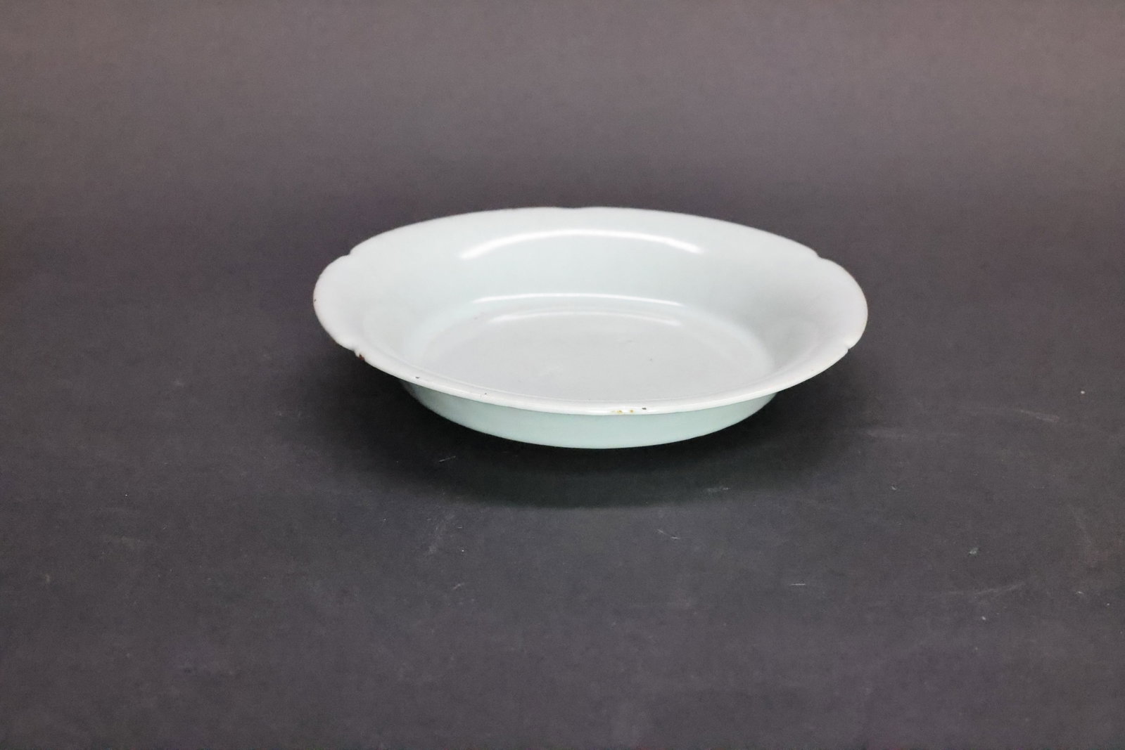 A 'Ru' Sky-Blue Glazed Mallow-Shaped Washer, Song Dynasty: Estimated Date: Late Northern Song Dynasty. Identified as an imperial Ru ware foliate-rim brush washer (bi xi) produced for the court.Attribution: The washer is covered in a remarkably even sky-blue (