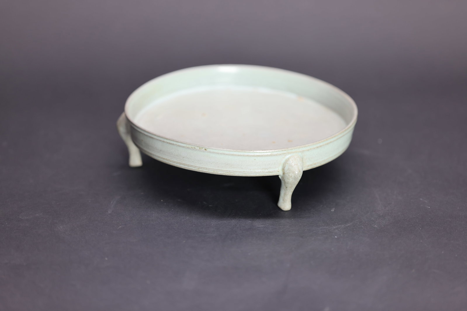 An Exceptionally Rare 'Ru' Sky-Blue Glazed Tripod Washer, Northern Song Dynasty: Estimated Date: Northern Song Dynasty. Identified as an imperial Ru ware tripod brush washer created for scholarly use at the imperial court.Attribution: The vessel is covered in a soft, opalescent sk