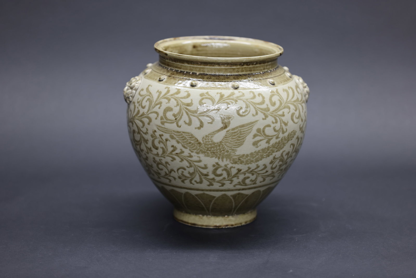 A 'Cizhou' White-Ground Brown-Decorated 'Drum-Nail' Jar with 'Makara-Headed' Pushou Handles and (1 of 8)