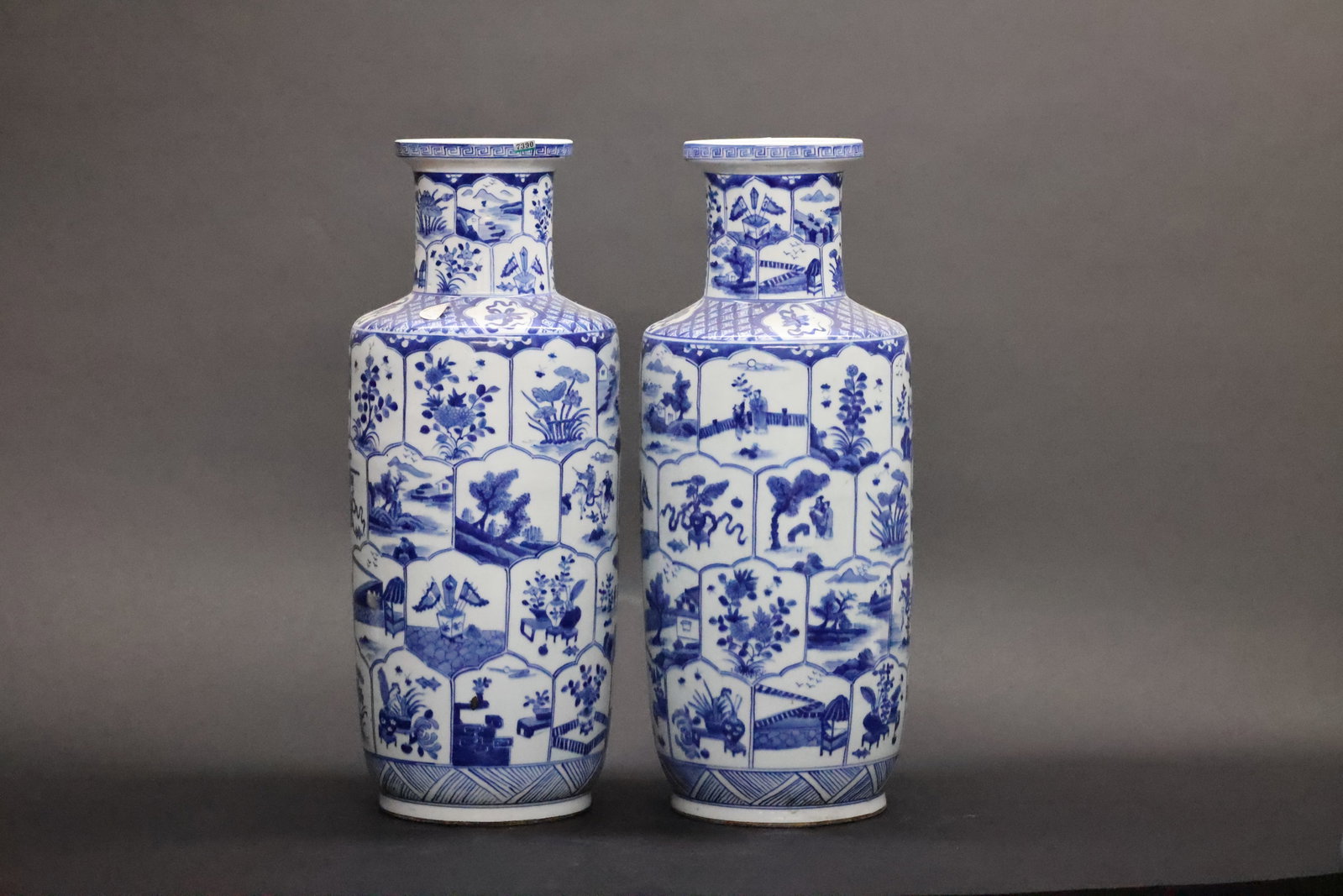 A Pair of Blue and White 'Rouleau' Vases, Kangxi Period: Estimated Date: Kangxi Period, Qing Dynasty. Attributed to the Jingdezhen kilns as a matched pair of blue and white bangchui (club-shaped) vases intended for display.Attribution: Each vase is of the c