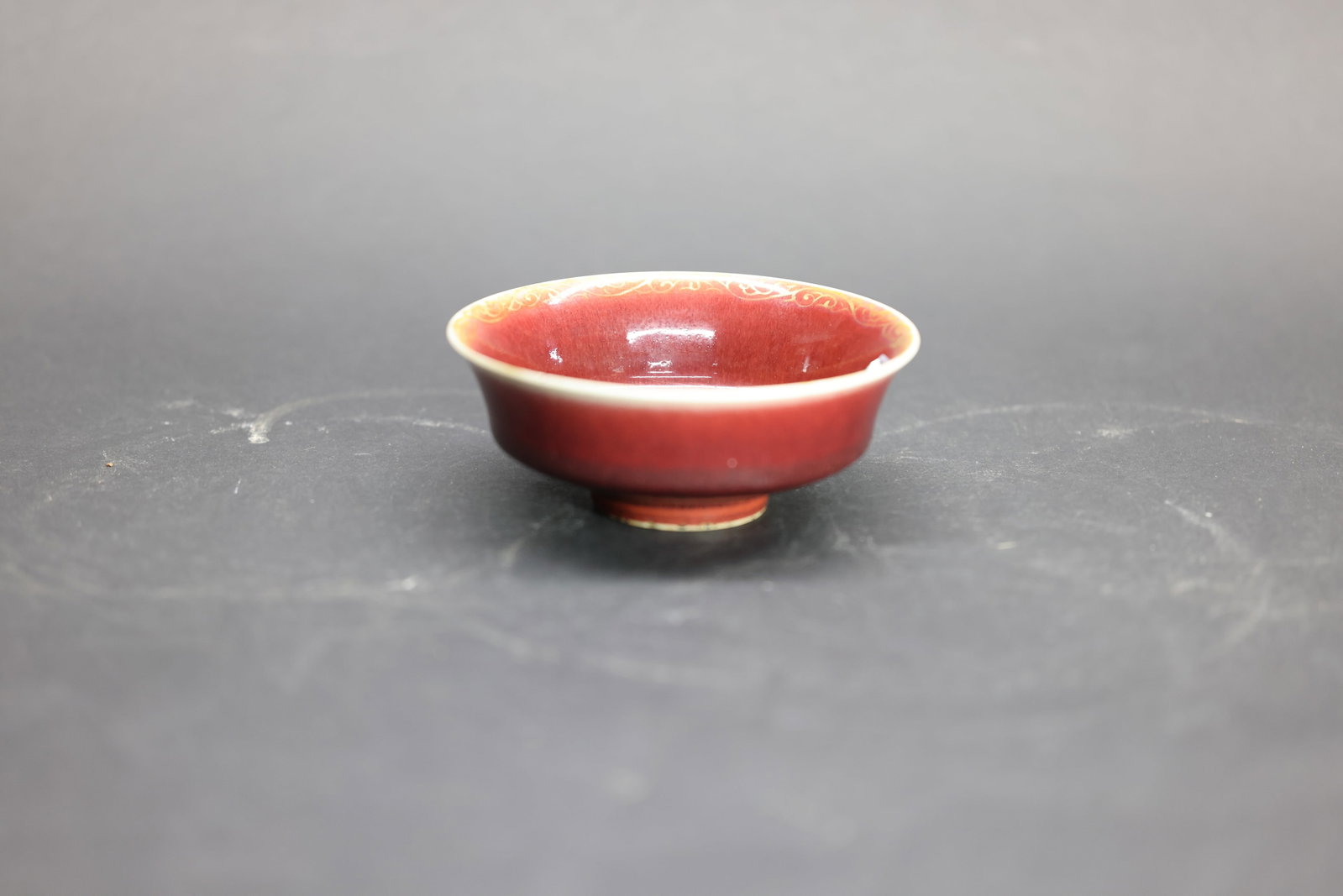 A Flambé and 'Langyao' Red-Glazed 'Phoenix' Washer, Qing Dynasty: Estimated Date: Mid to Late Qing Dynasty. Attributed to the Jingdezhen kilns as a Langyao copper-red glazed brush washer with gilt decoration for the scholar's desk.Attribution: The washer is covered 