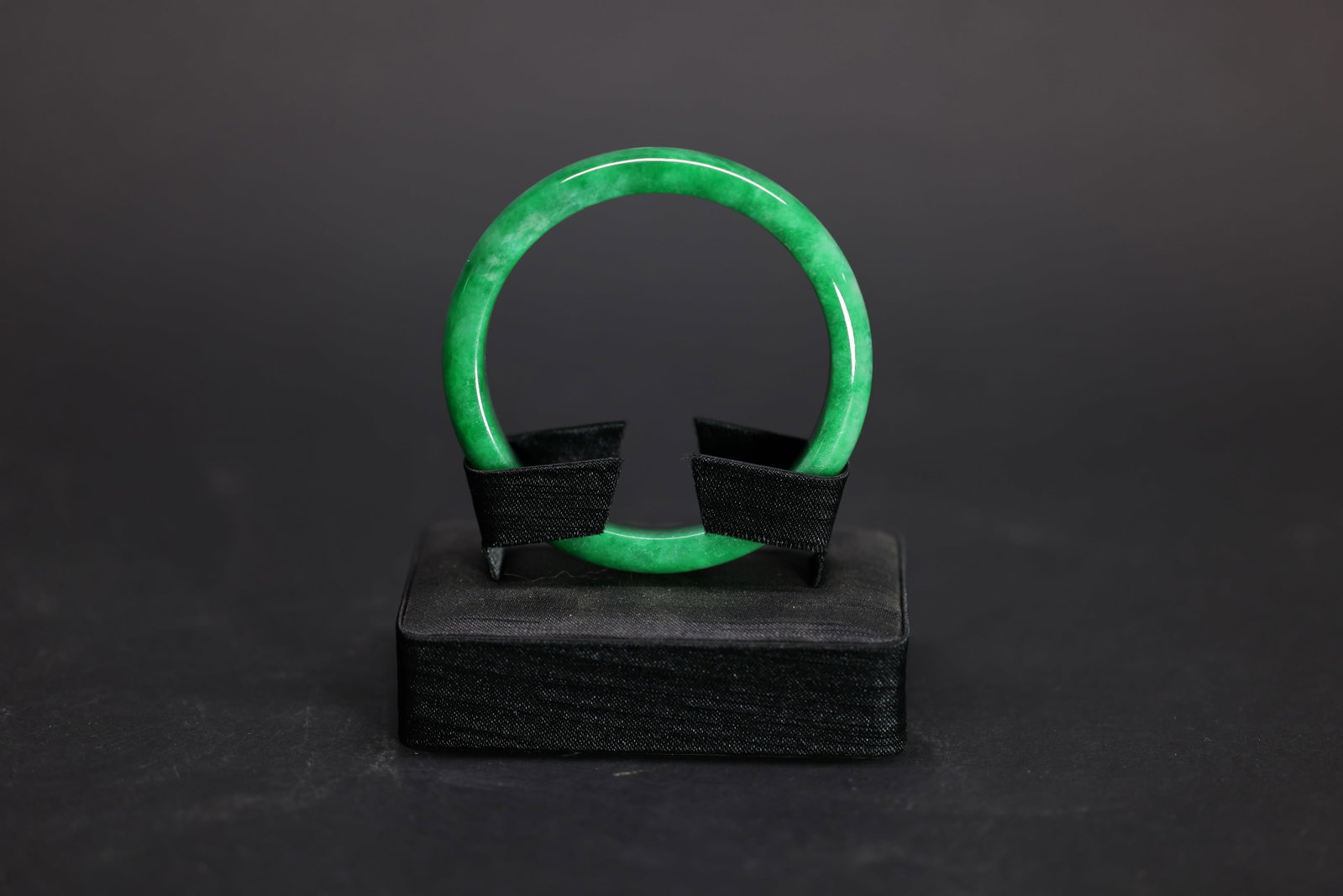 A Highly Important Green Jadeite Bangle