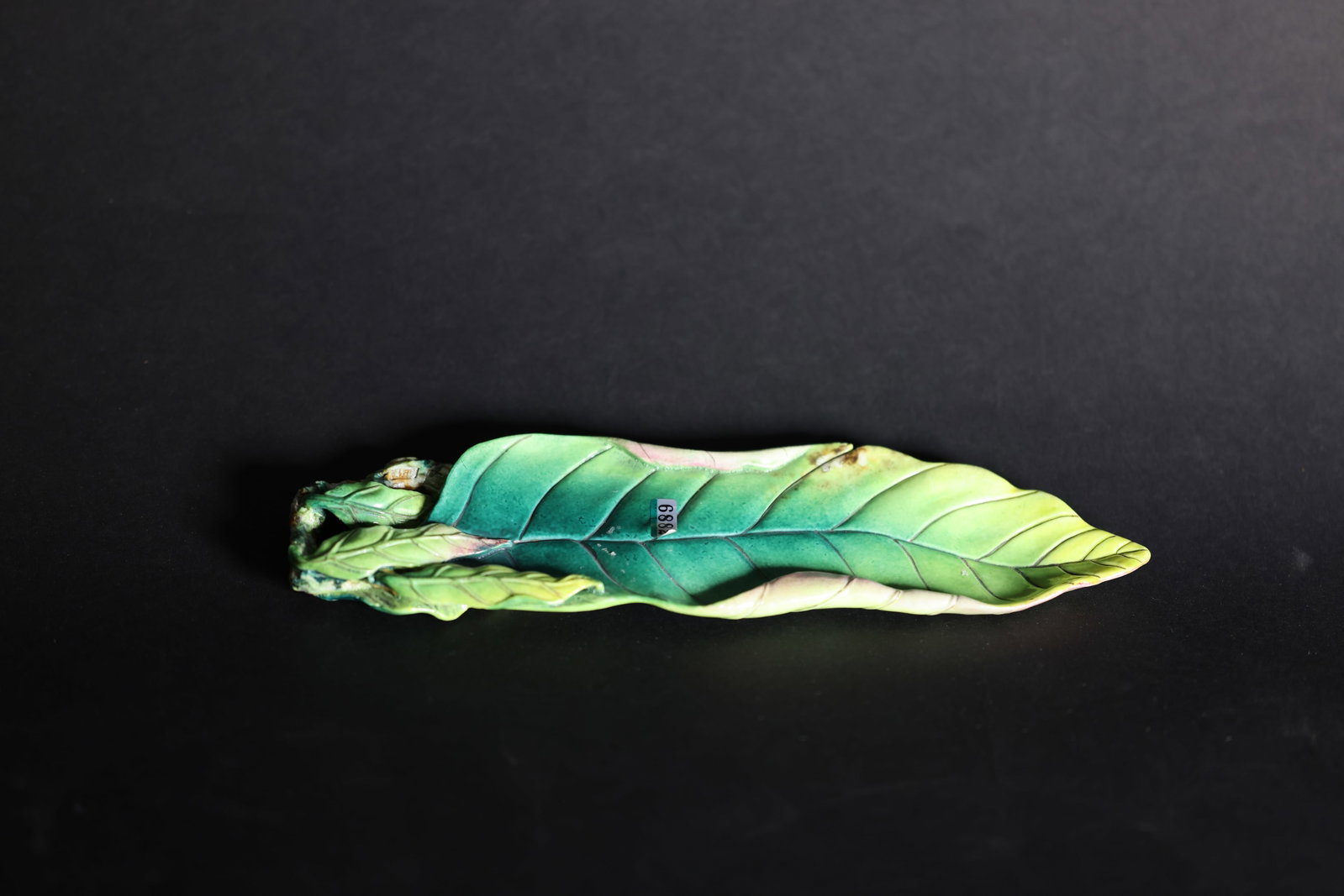 A Famille-Rose 'Autumn Leaf' Brush Washer, Qing Dynasty: Estimated Date: Late Qing Dynasty. A naturalistic porcelain scholar's implement modeled in the form of an autumn leaf.Attribution: This finely modeled scholar's object is fashioned in the form of a na