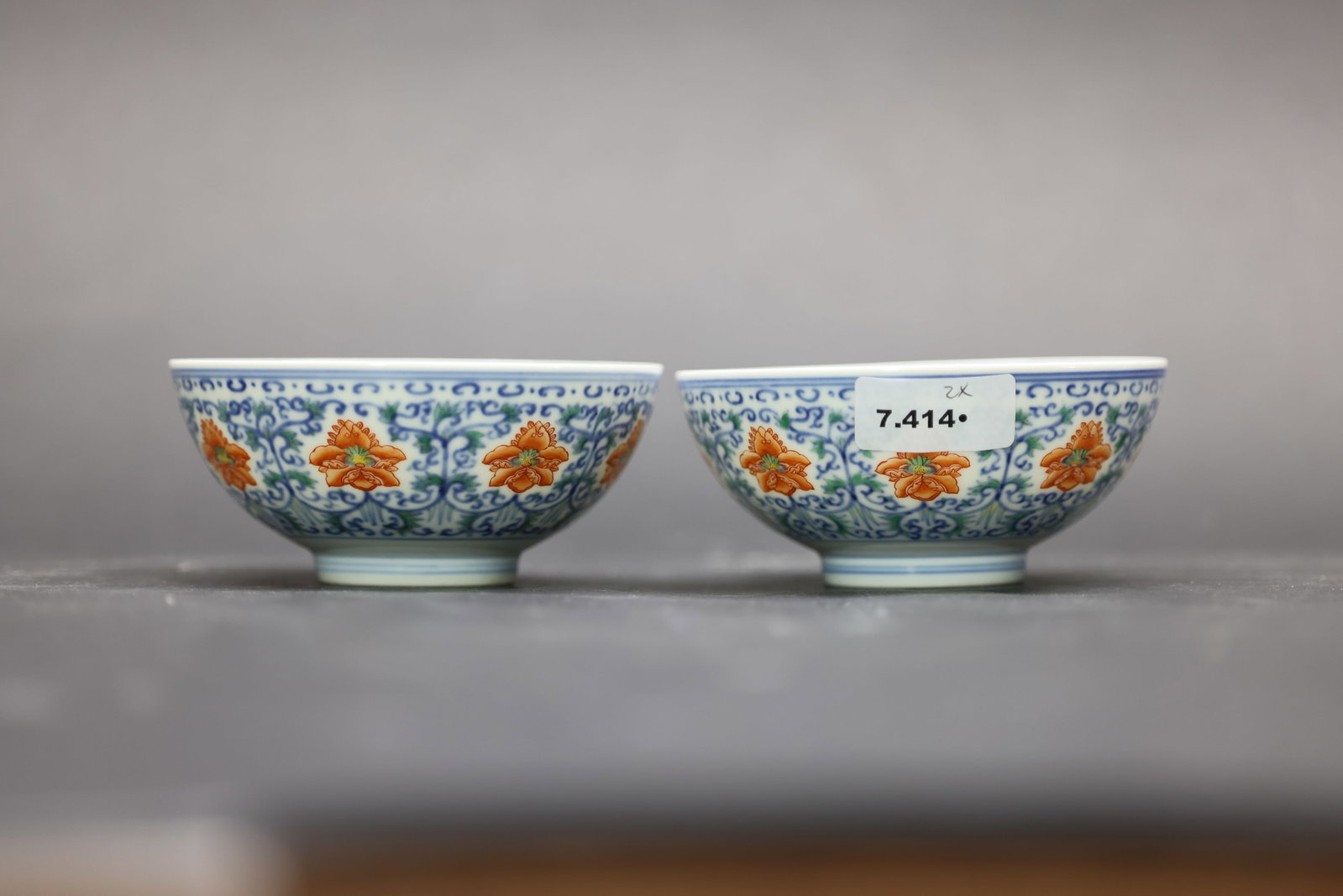 A Pair of Blue and White and Iron-Red 'Scrolling Florals' Bowls, 'Ruidi Tuisitang Zhi' Marks, Qing: Estimated Date: Daoguang Period, Qing Dynasty. A pair of imperial-style famille rose porcelain bowls bearing the "Ruiti Tuisitang Zhi" hall mark.Attribution: The pair is finely potted and covered in a