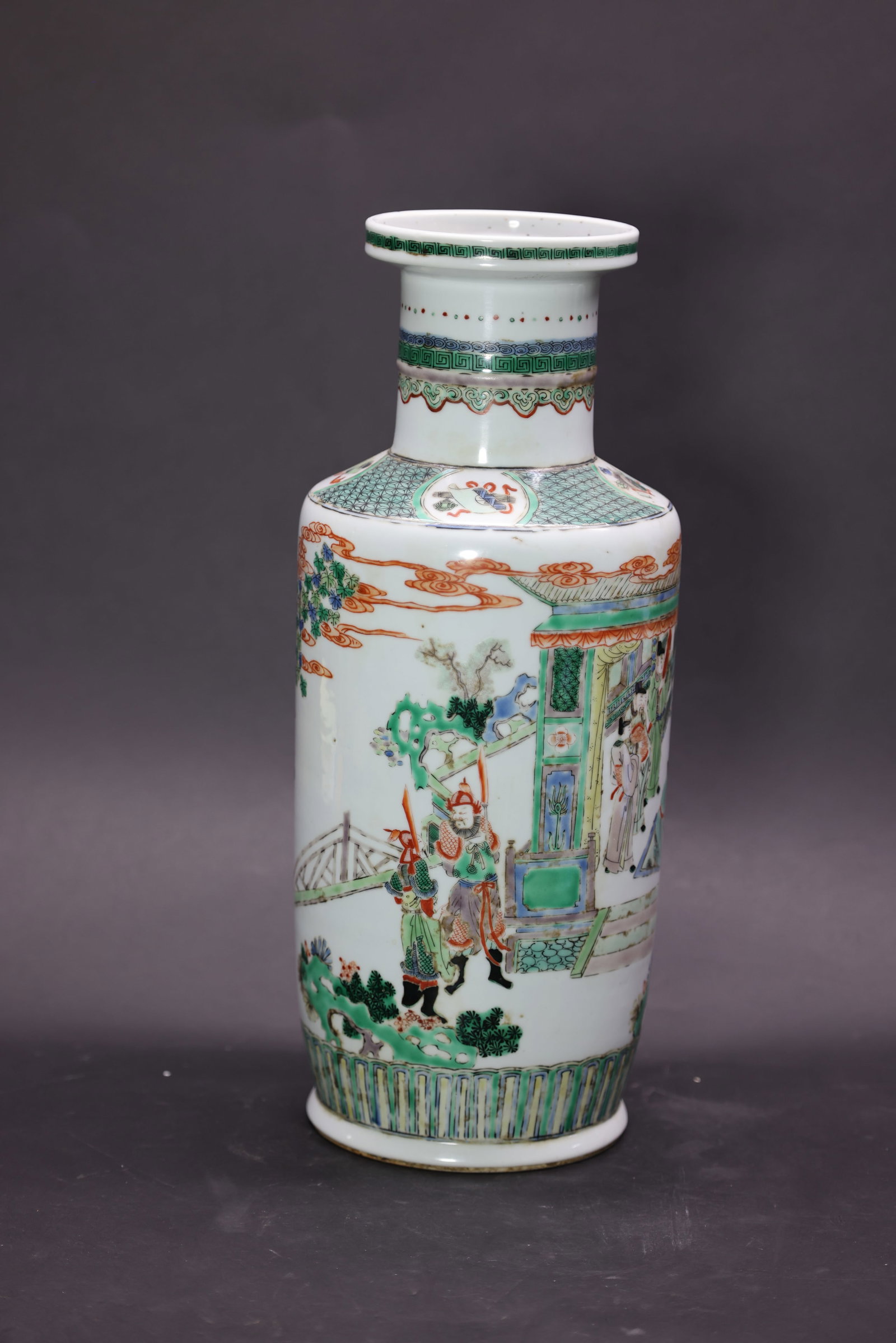 A 'Kangxi'-Style 'Wucai' 'Warriors' Rouleau Vase, Late Qing Dynasty: Estimated Date: Guangxu Period, Late Qing Dynasty. A Kangxi-style famille verte bangchuiping (club-shaped vase) bearing an apocryphal "Made during the Kangxi Reign of the Great Qing" mark.Attribution: