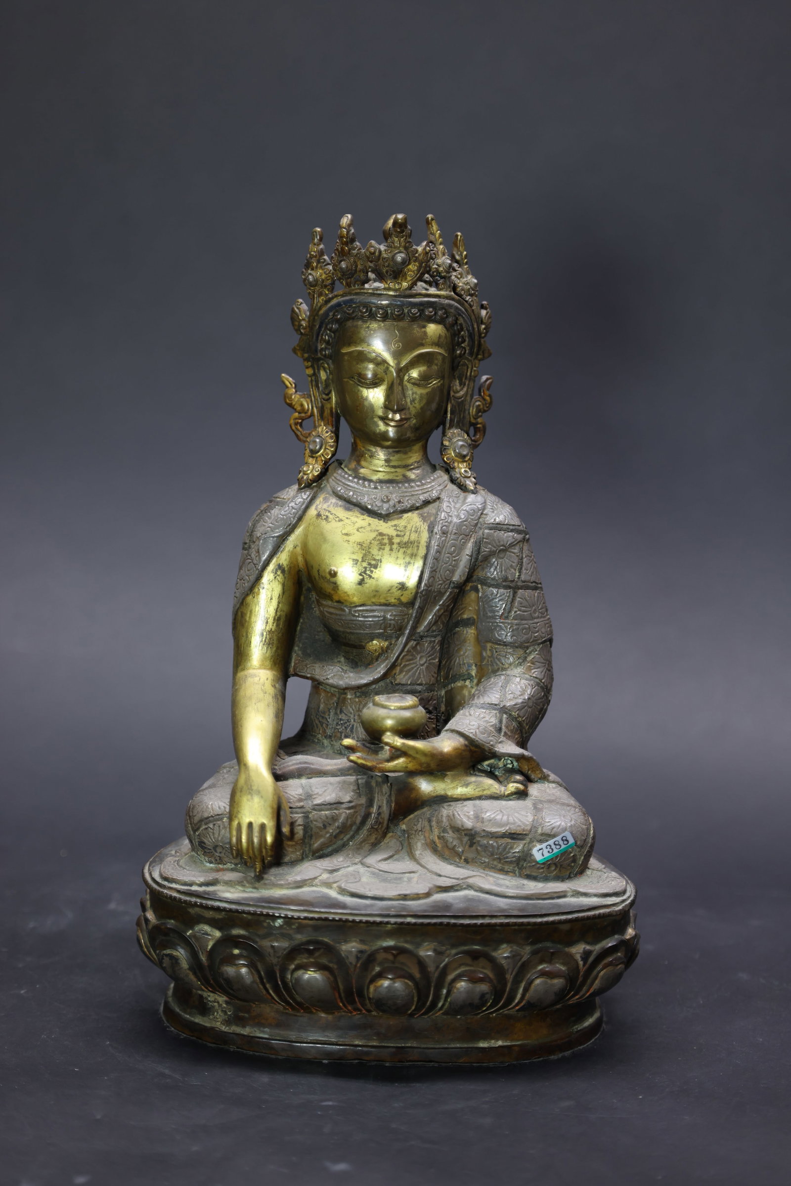 A Rare Partly Silvered-Bronze Figure of a Crowned Shakyamuni Buddha, Qing Dynasty: Estimated Date: Qing Dynasty. A Tibetan gilt and silvered bronze figure of ??kyamuni Buddha.Attribution: The sculpture depicts ??kyamuni Buddha seated in vajr?sana upon a finely cast double-lotus thro