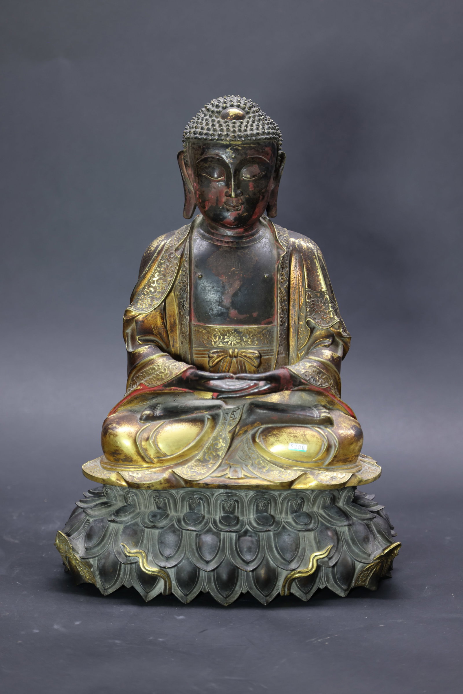 A Partly Gilt-Bronze Figure of Shakyamuni Buddha, Qing Dynasty: Estimated Date: Qing Dynasty. A Chinese gilt-bronze seated figure of ??kyamuni Buddha.Attribution: The sculpture depicts ??kyamuni Buddha seated in meditation with the hands arranged in dhy?na mudr? (