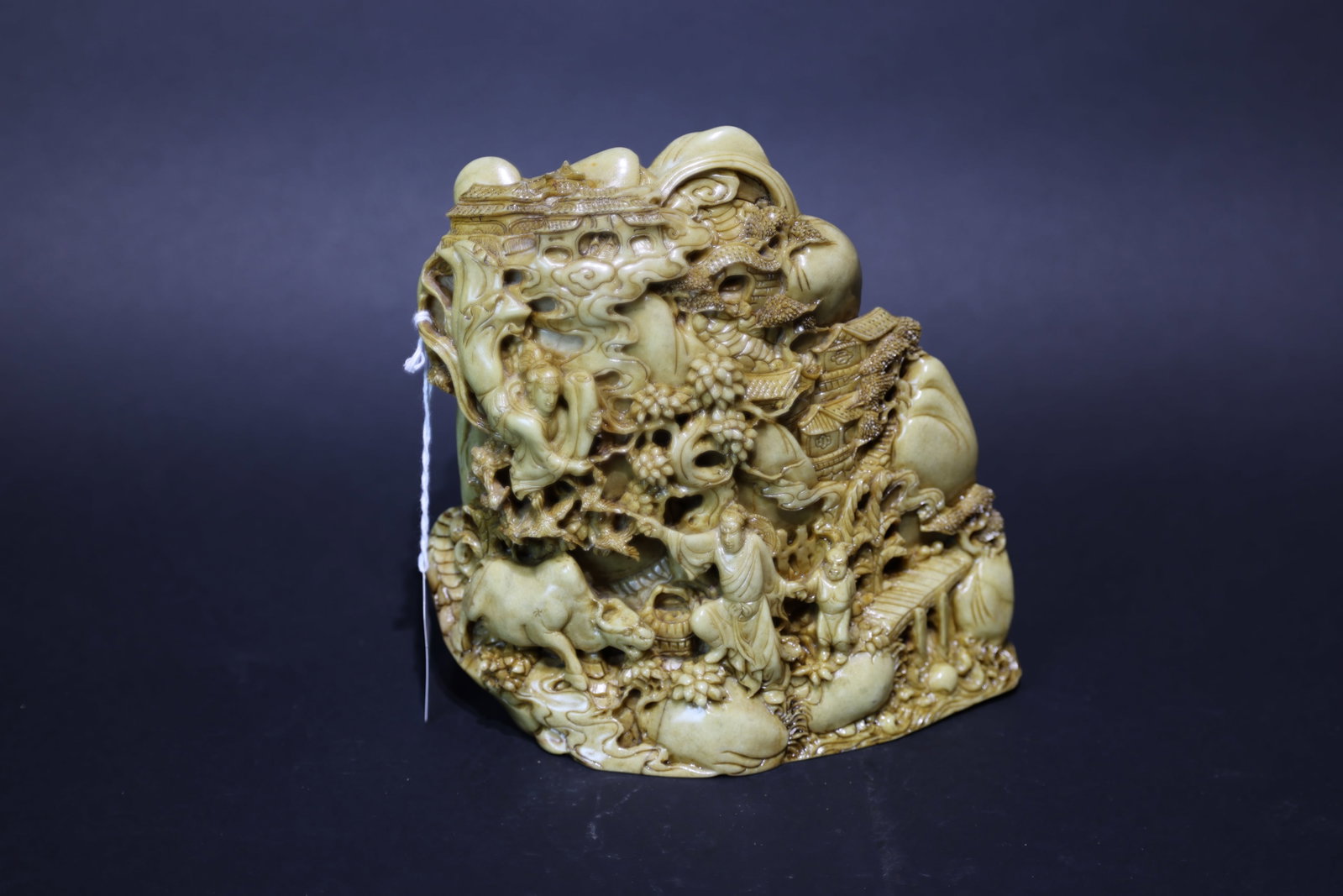 A Shoushan Stone Multi-Layered Openwork 'Pastoral Farming and Studying' Scholars' Rock, Qing Dynasty: Estimated Date: Late Qing Dynasty. A Shoushan stone landscape and figural scholar's mountain carving (shanzi).Attribution: The carving is executed from a single piece of pale yellowish-green Shoushan 