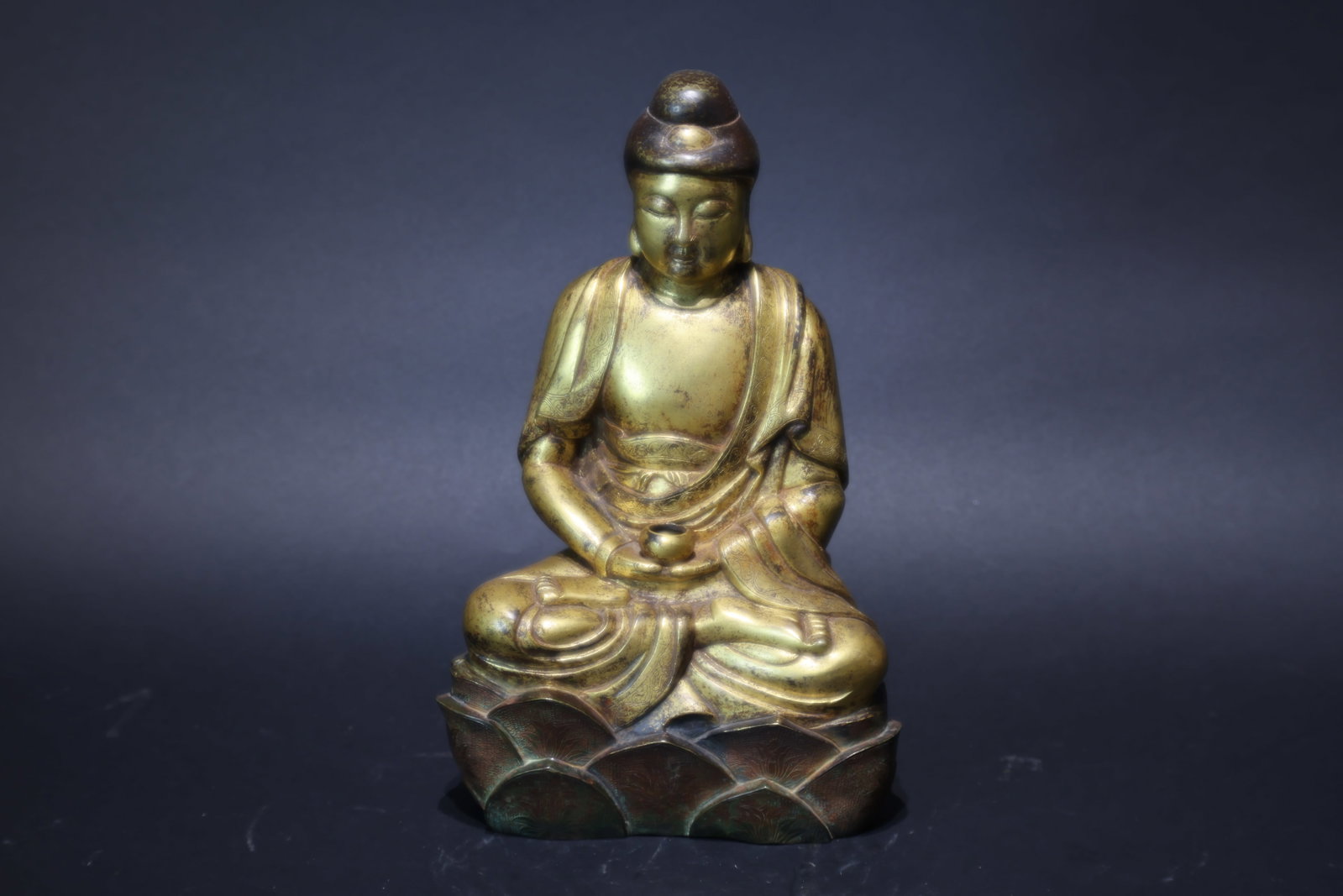 A Gilt-Bronze Figure of Bhaisajyaguru, Qing Dynasty: Estimated Date: Mid to Late Qing Dynasty. A gilt-bronze figure of the Medicine Buddha (Bhaisajyaguru).Attribution: Finely cast in bronze using the traditional lost-wax process as a single integral cas