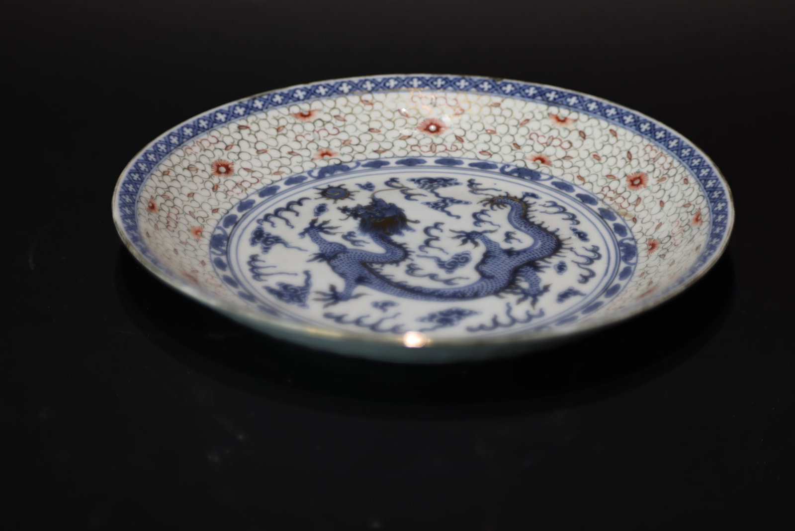A Rare 'Blue and White', Iron-Red and Gilt 'Linglong' 'Dragon' Export Dish, Late Qing Dynasty: Estimated Date: Late Qing Dynasty. A Canton export reticulated ("Linglong") porcelain dragon dish.Attribution: The dish is a fine example of late Qing export porcelain produced in Guangzhou (Canton) f