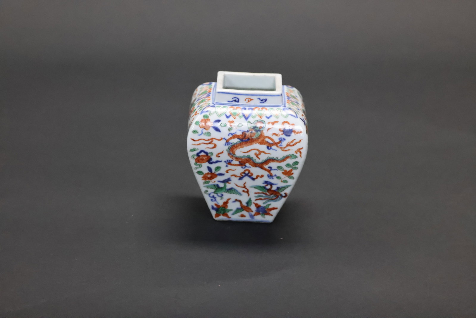 A 'Dragon and Phoenix' Wucai Square Small Jar, Late Qing Dynasty / Republic Period: Estimated Date: Late Qing Dynasty to the Republican Period. A wucai (famille verte-style) porcelain jar, bearing an apocryphal Wanli reign mark.Attribution: This finely potted square, tapering porcela