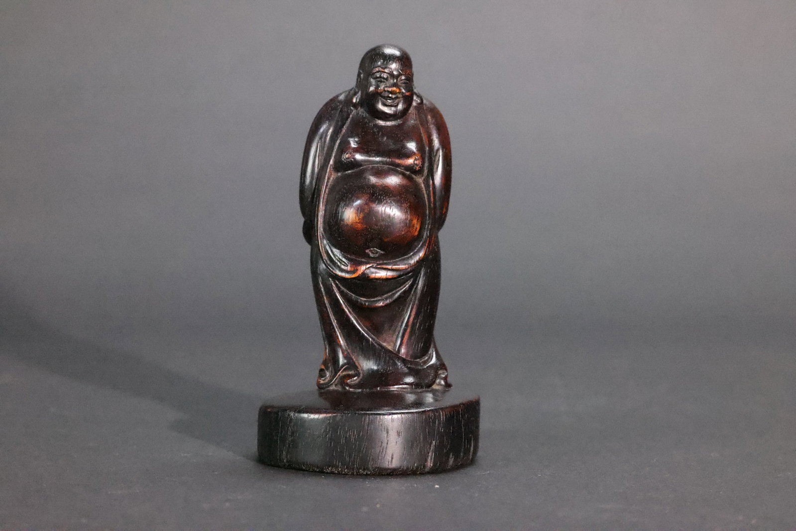A Zitan Figure of a Standing Maitreya, Late Qing Dynasty / Republic Period: Estimated Date: Late Qing Dynasty to the Republican Period. A carved zitan (Pterocarpus santalinus) figure of Maitreya (Budai).Attribution: This finely carved figure of Maitreya (Budai) is executed fr