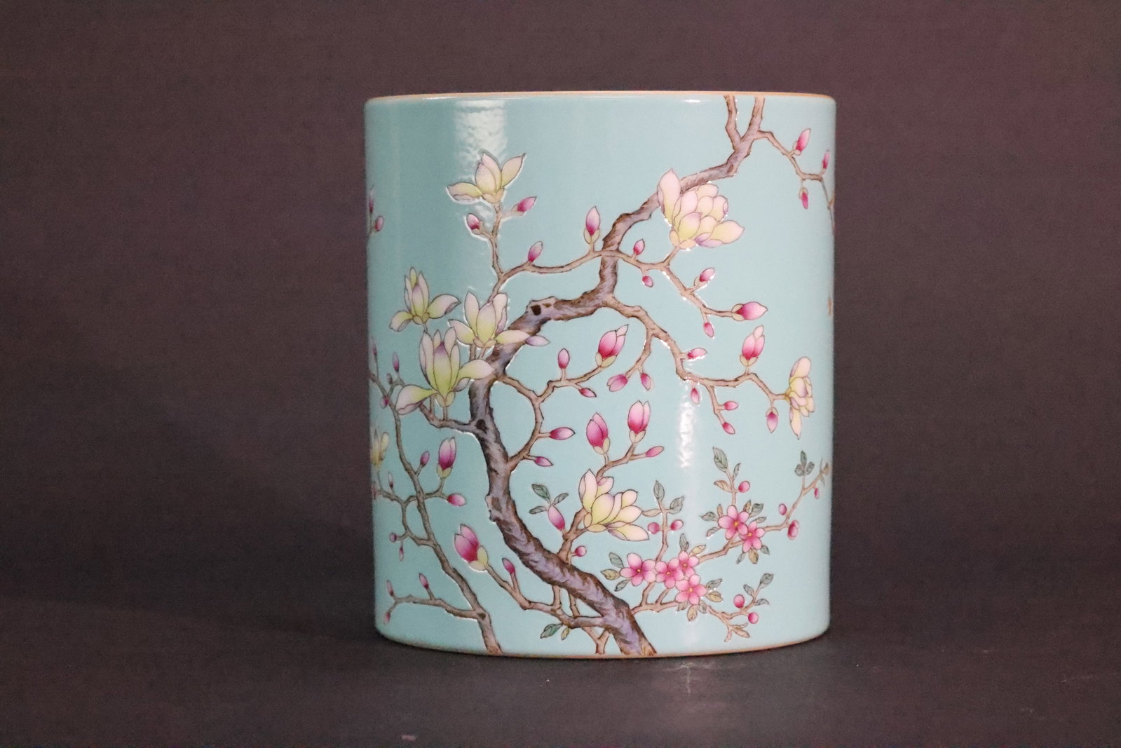 A 'Qing Qianlong' Mark Famille Rose Turquoise-Ground 'Magnolia and Butterfly' Cylindrical Brush Pot,: Dimensions:Height: 14 cm (5.5 in.)Diameter: 12.3 cm (4.8 in.)