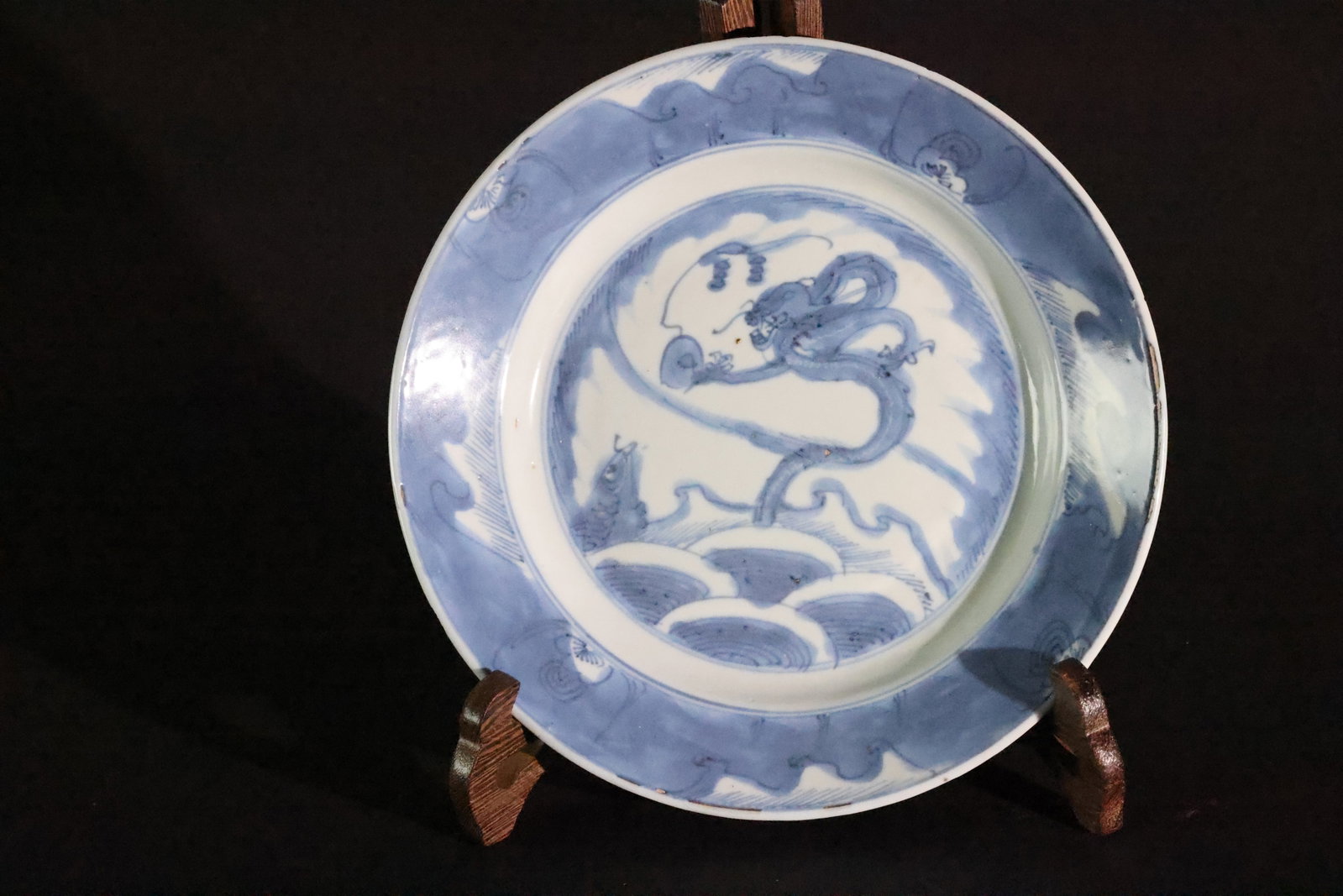 A Blue and White 'Fish Transforming into a Dragon' Rimmed Charger, Qing Dynasty, Kangxi Period: Estimated Date: Middle to Late Kangxi period, Qing Dynasty (late 17th to early 18th century). A Jingdezhen blue-and-white porcelain dish from a private kiln.Attribution: This blue-and-white porcelain 