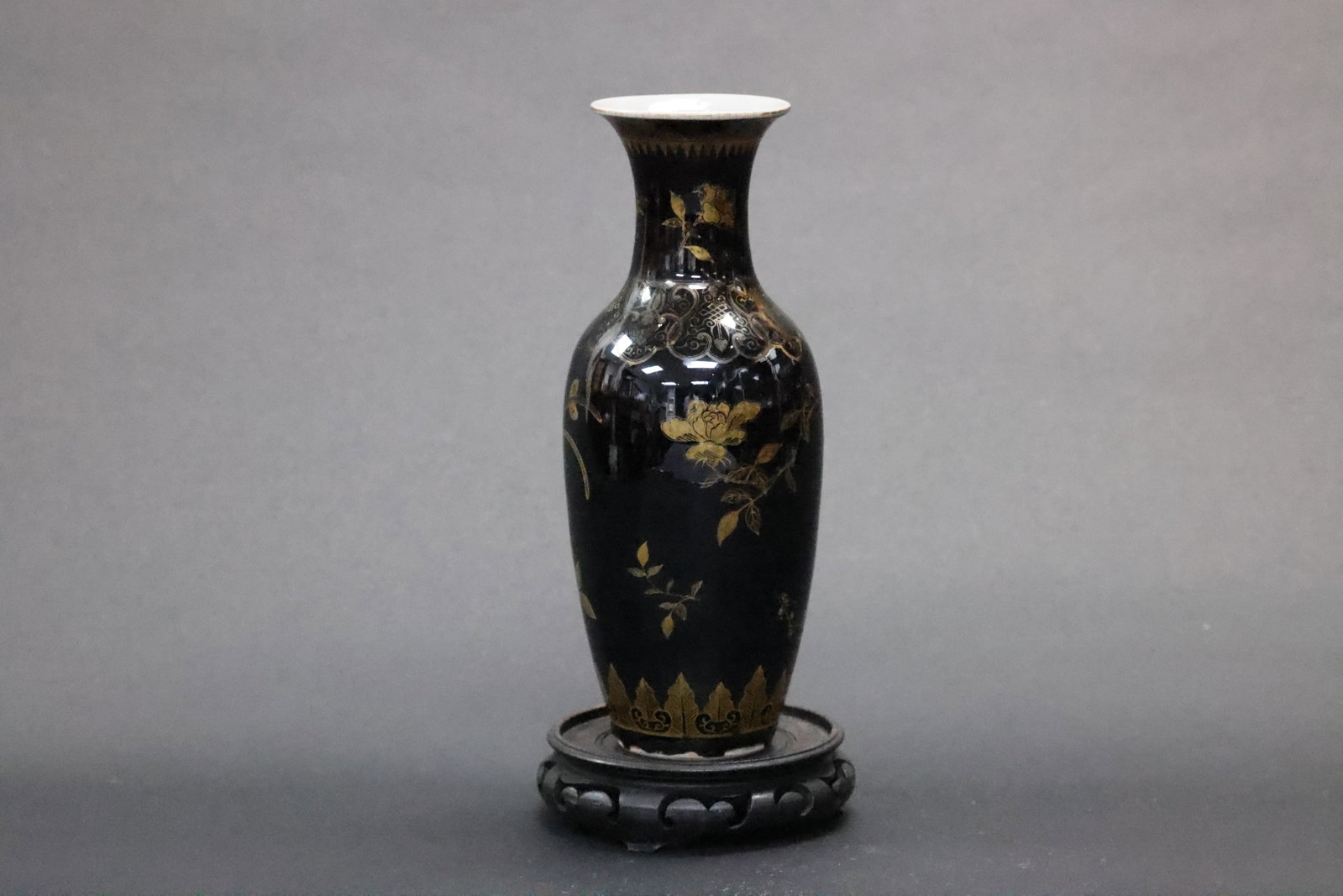 A Mirror-Black Glazed and Gilt-Decorated 'Anbaoxian and Floral Scrolls' Guanyin Vase, Late Qing: Estimated Date: Late Qing Dynasty to the Republican period (late 19th–early 20th century). A black-ground gilt-decorated display vase in imitation of Kangxi style.Attribution: This decorative porcel