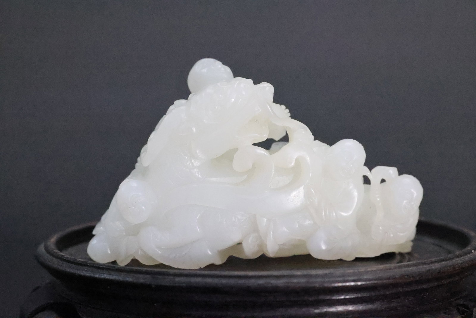 A White Jade 'Boy and Dragon-Carp' Openworked Group, Qing Dynasty (1 of 6)