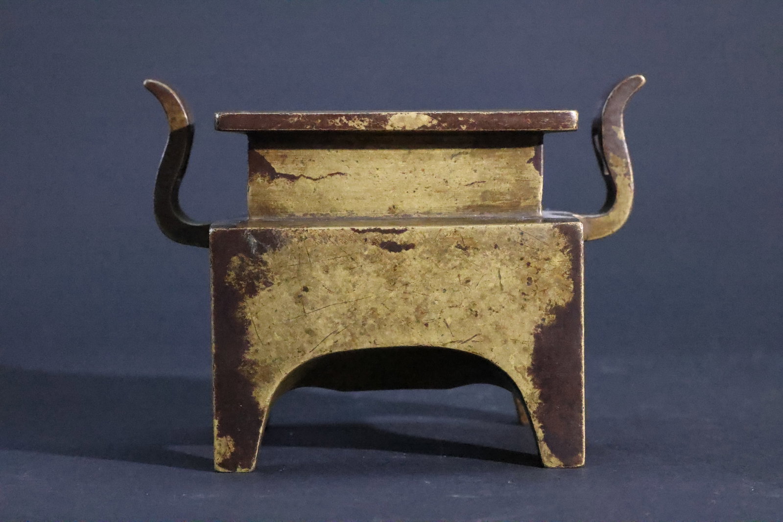 A Bronze 'Macao' (Trough-Shaped) Censer, 'Da Ming Xuande Nian Zhi' Mark, Qing Dynasty: Estimated Date: Qing Dynasty. A bronze rectangular "Macao-trough" incense burner in the style of the Xuande period.Attribution: This rectangular bronze incense burner is attributed to the Qing Dynasty