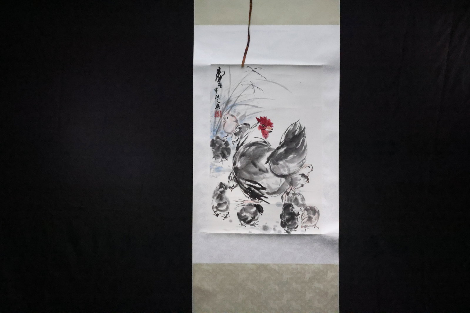 A Hanging Scroll of 'Chickens', Ink and Colour on Paper, In the Style of Huang Zhou: Estimated Date: Modern. A Chinese ink painting in the style of Huang Zhou depicting a hen with seven chicks.Attribution: This freehand (xieyi) ink painting is a modern work executed in the style of Hu