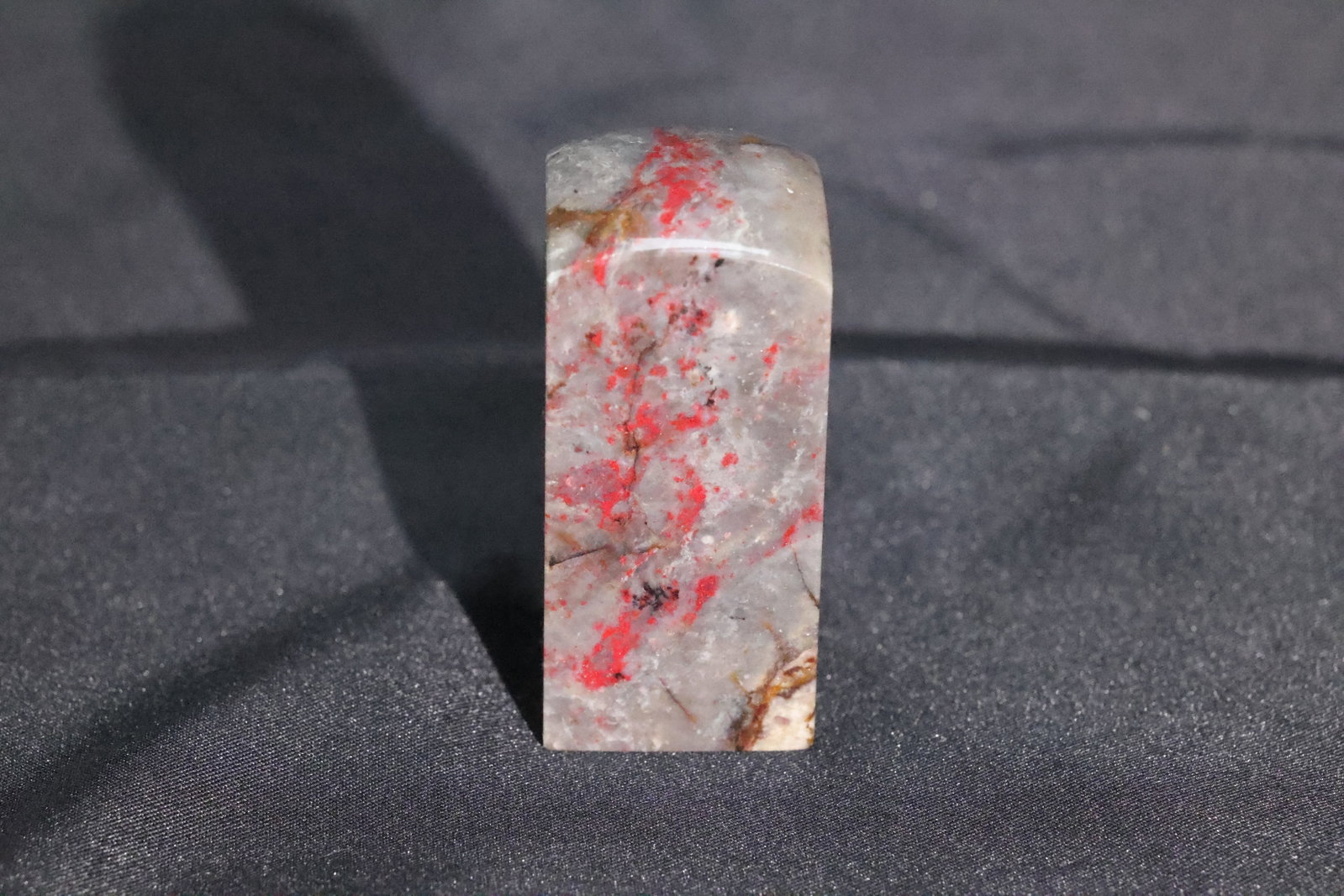 A Rectangular Chicken-Blood Stone Seal Blank: Estimated Date: Modern. A Changhua chicken blood stone seal blank.Attribution: This square seal stone is carved from Changhua chicken blood stone, featuring a translucent grayish-white frozen matrix w