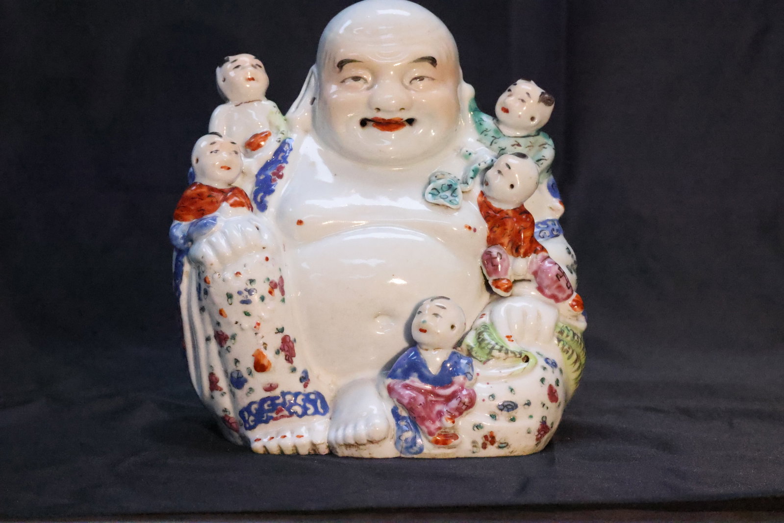 A Famille Rose Figure of Budai with Five Boys: Estimated Date: Late Republic period to the early People's Republic of China (c. 1940s–1950s). A Jingdezhen famille rose figure of the Laughing Buddha with Five Children.Attribution: This folk