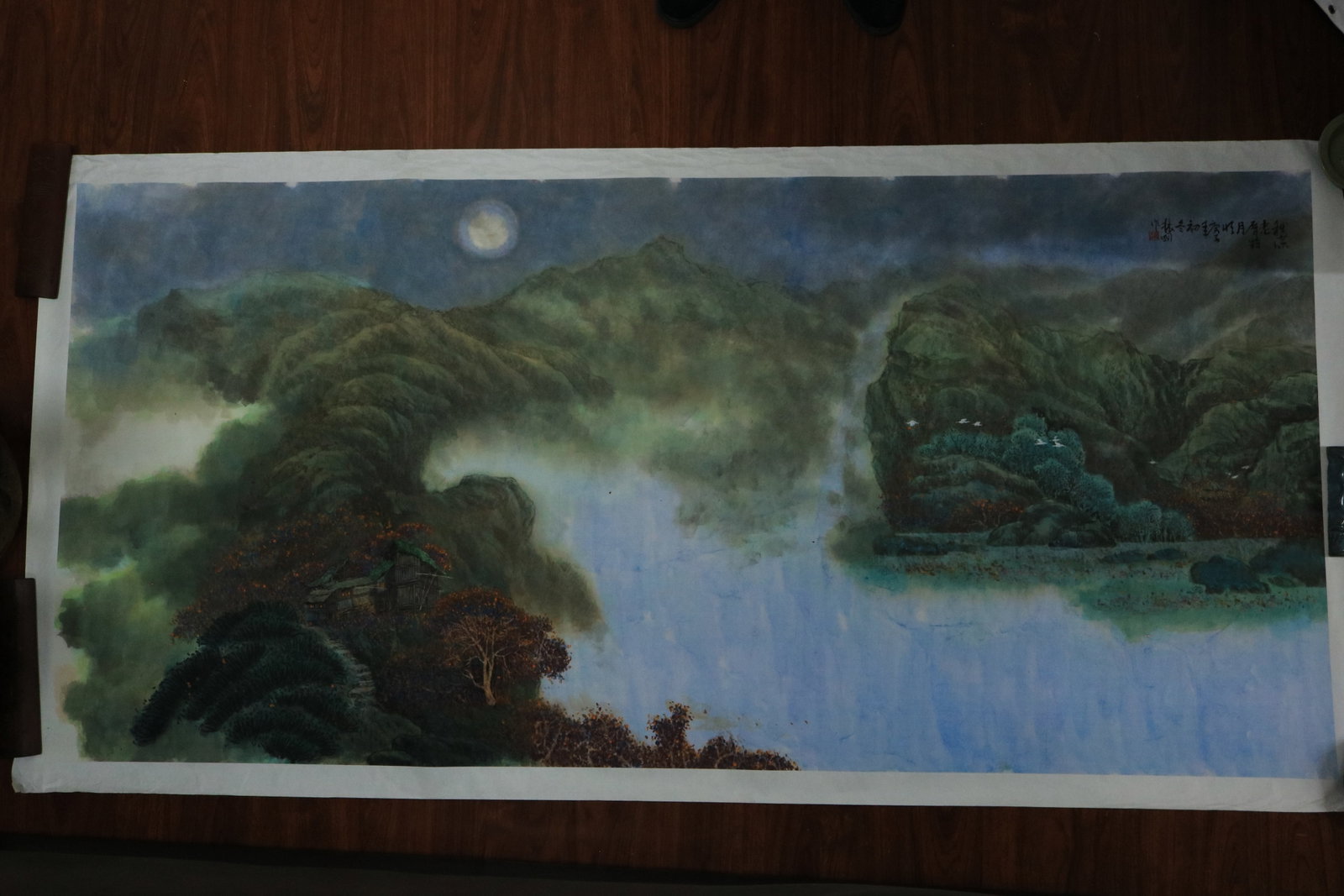 Jiang Zhenguo, Moonlit Autumn Stream and Old Village: Landscape in Polychrome on Paper: Composition: Executed on a full six-foot sheet of paper, this expansive contemporary landscape presents a tranquil moonlit mountain valley in richly layered mineral pigments. Rolling mountains are