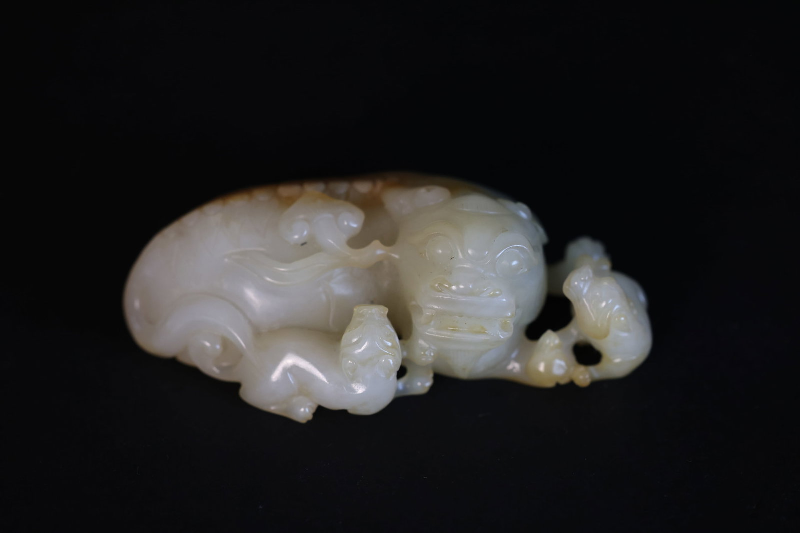 Qing Dynasty White Jade Carved "Lion Teaching Cubs" Handheld Ornament: Natural age wear and patina; otherwise in excellent overall condition. H 3.7cm W 10cm