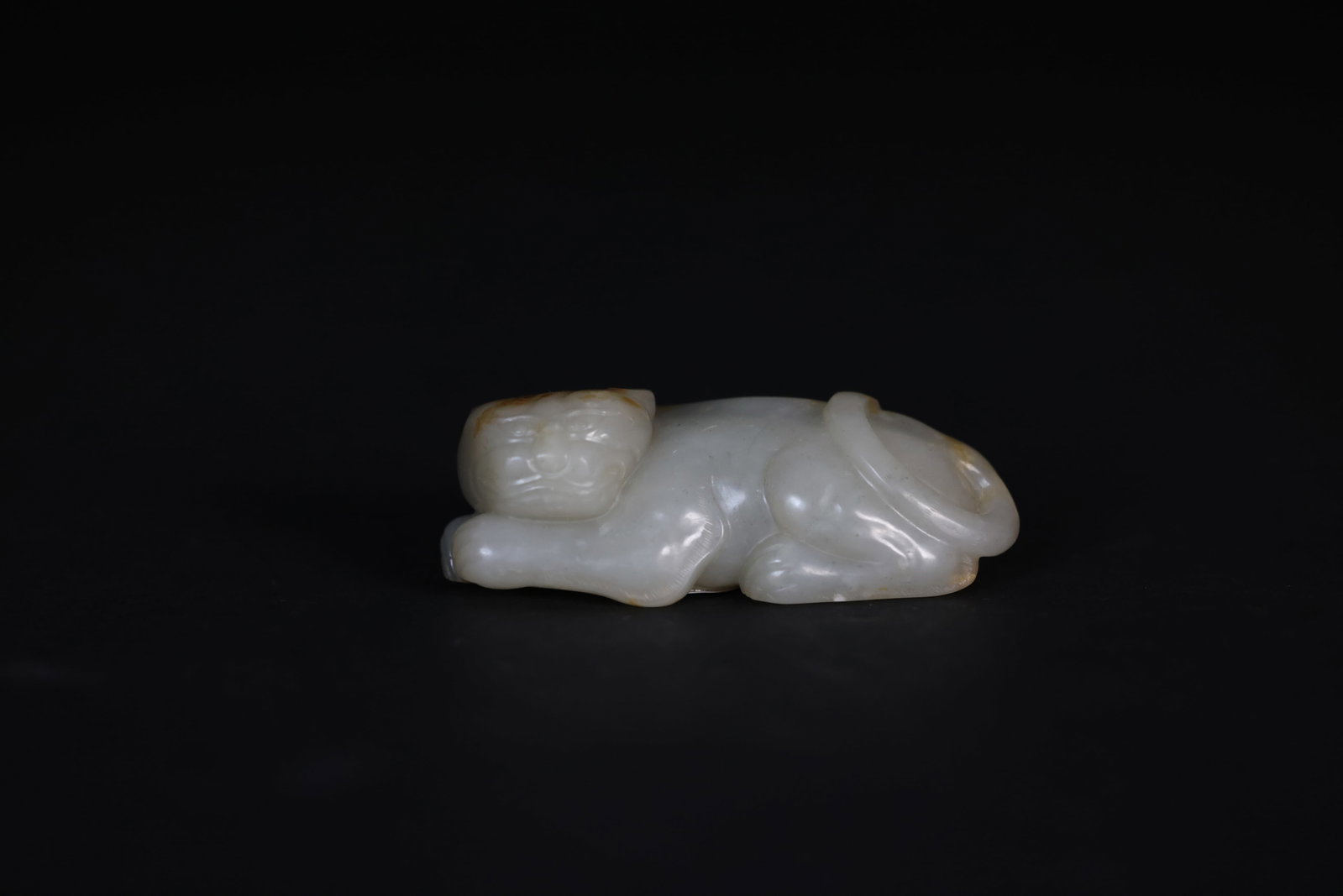 Carved Pale Grey-White Jade Figure of an Auspicious Beast: Naturally aged with patina; overall in excellent condition. H 3cm W 7.8cm