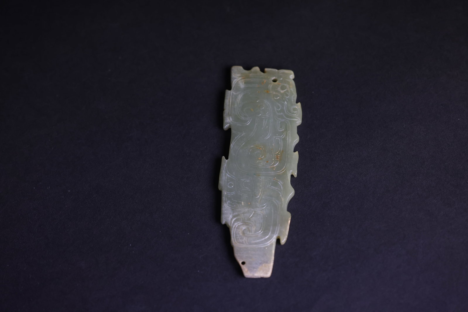 Western Zhou-style Green Jade Pendant with Carved Bird and Beast Motifs: Natural age patina with partial staining; otherwise in excellent overall condition. H 10.7 cm W 3.8 cm