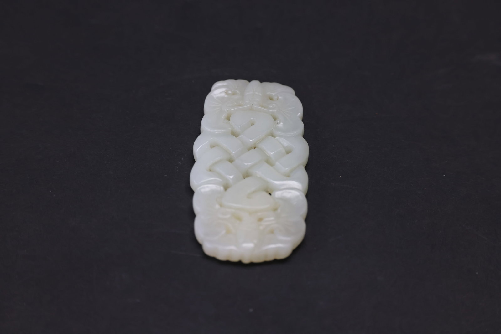 White Jade Plaque Carved with Twin Butterflies and Eight Auspicious Motifs: Excellent condition H 7.4cm W 3.7cm