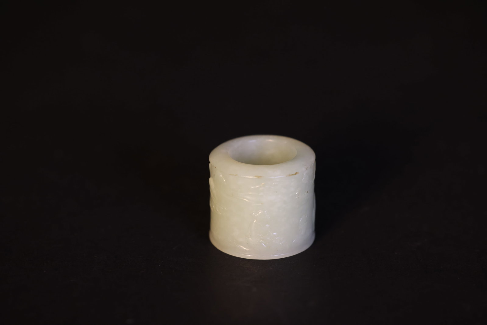 Greenish?white jade ring carved with landscape and figures: Naturally aged with patina; overall in excellent condition. H 3.2cm W 3.7cm