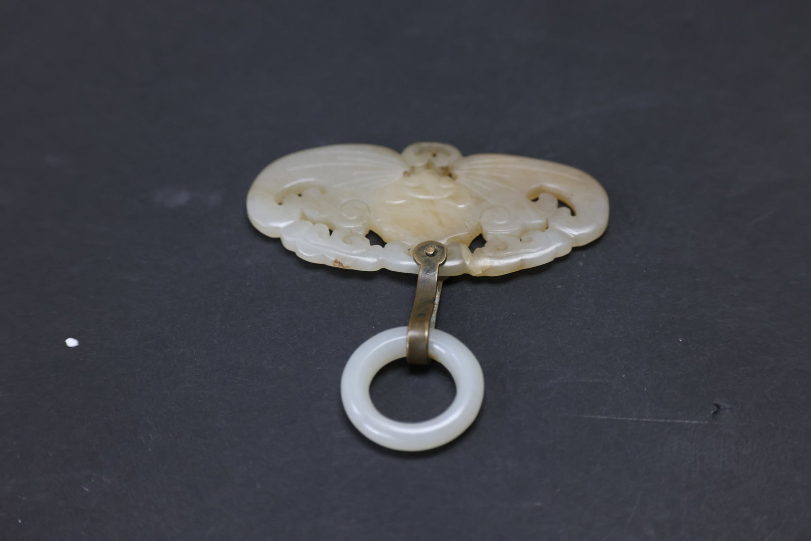 Qing Dynasty white jade butterfly pendant with bronze hook and jade ring: Naturally aged, with patina and signs of use; otherwise in overall excellent condition. H 3.3cm W 7cm