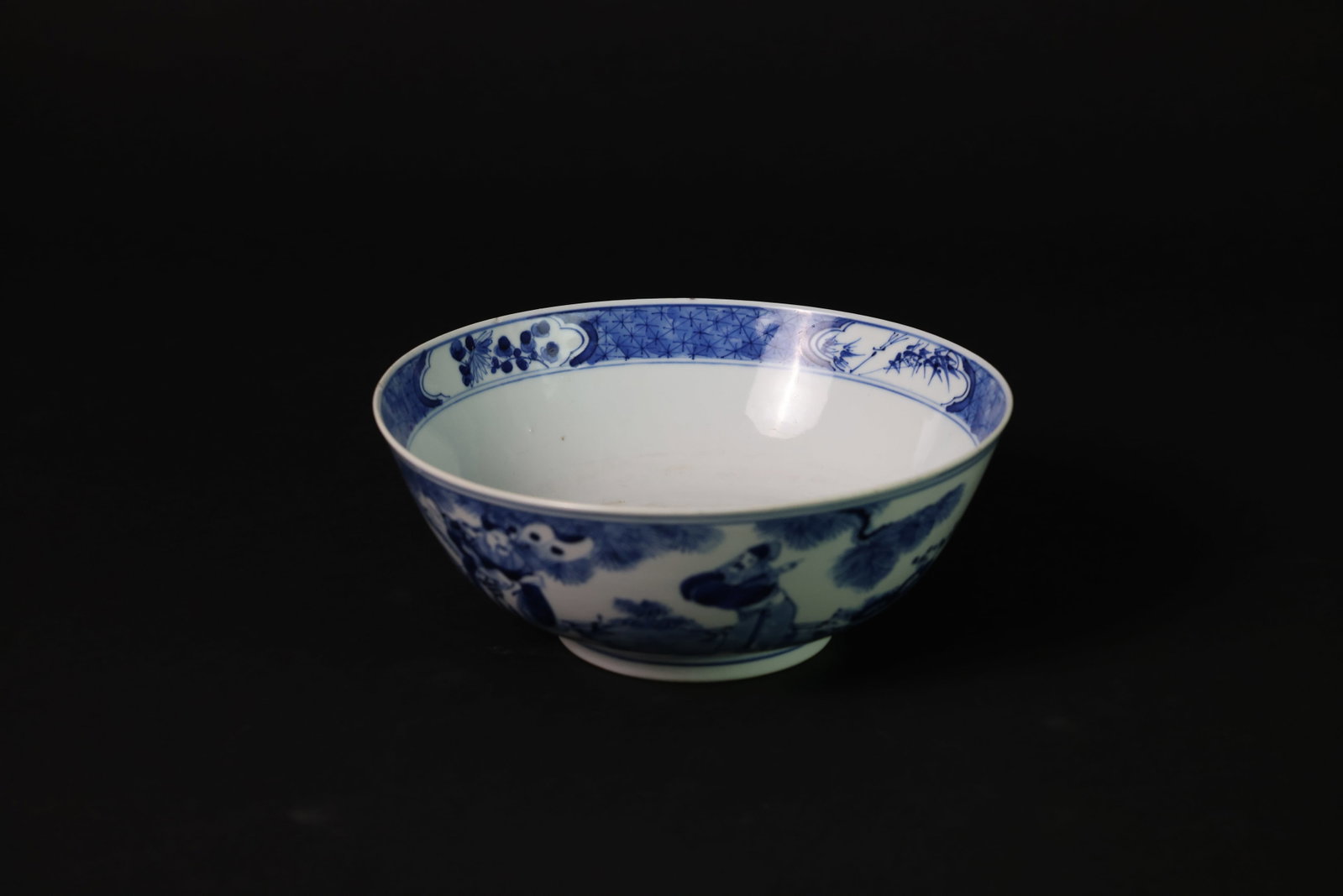 Late Qing blue-and-white Fu Lu Shou figural bowl, "Kangxi Nian Zhi" mark: Naturally aged with three small chips to the rim, each about the size of a sesame seed; a 6cm hairline to the rim; otherwise in overall good condition. H 9.2cm. W 23cm