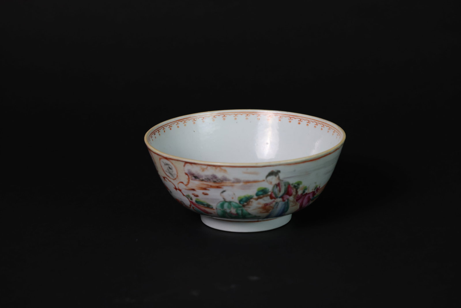 Qing Dynasty Famille Rose Bowl Depicting Figures and Landscape, Export Porcelain: Naturally aged; rim with a 3cm x 10cm area of glaze restoration; some natural color loss; rim with retouching; otherwise in overall good condition. H 7.9cm W 18.1cm