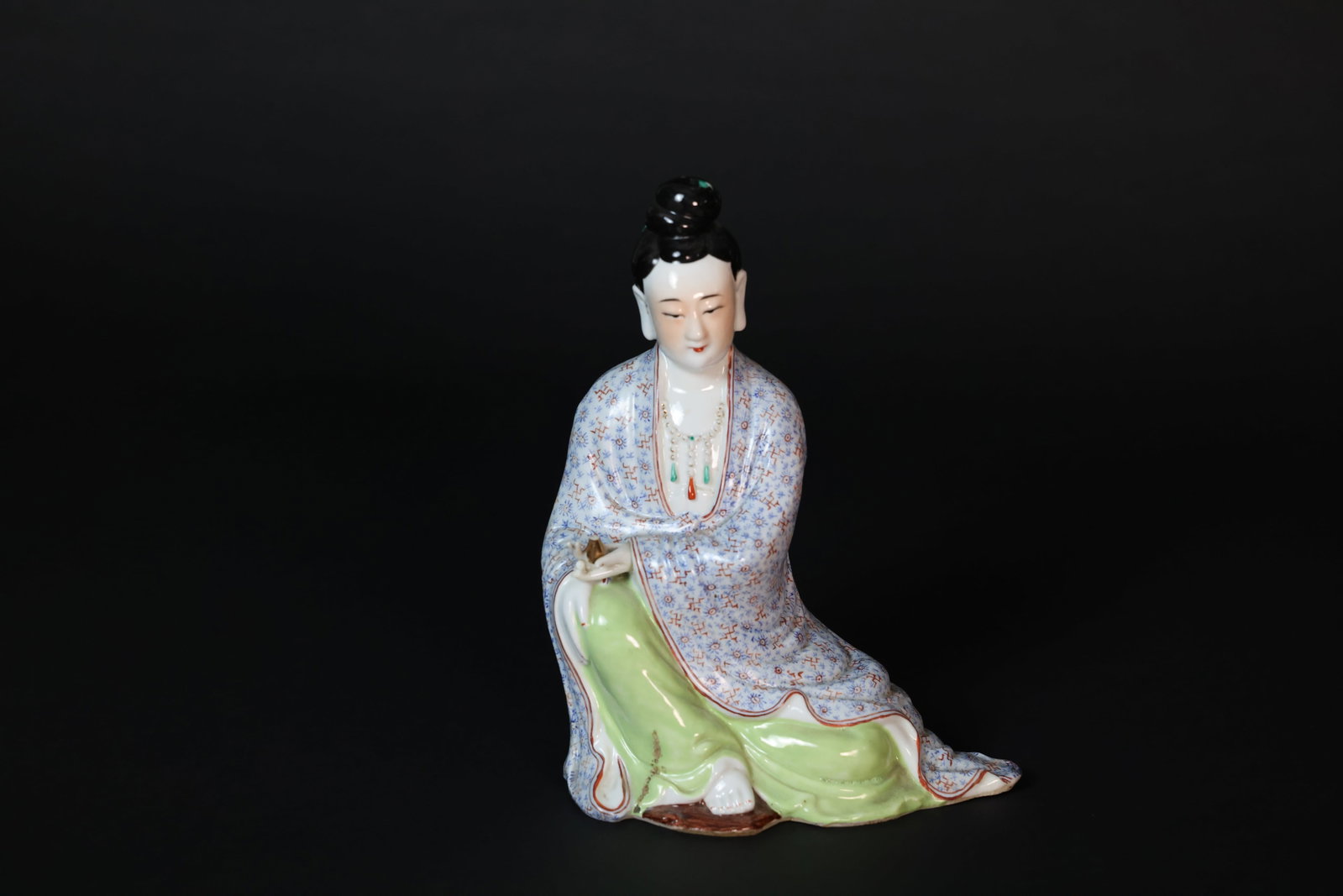 Republic of China Famille Rose Seated Lady Figure, "CHINA" Mark: Naturally aged; two fingers and the vase held in the hand are broken but retained. There is a 3.7 cm area of glaze loss on the robe. H 26.5cm W 18.5cm