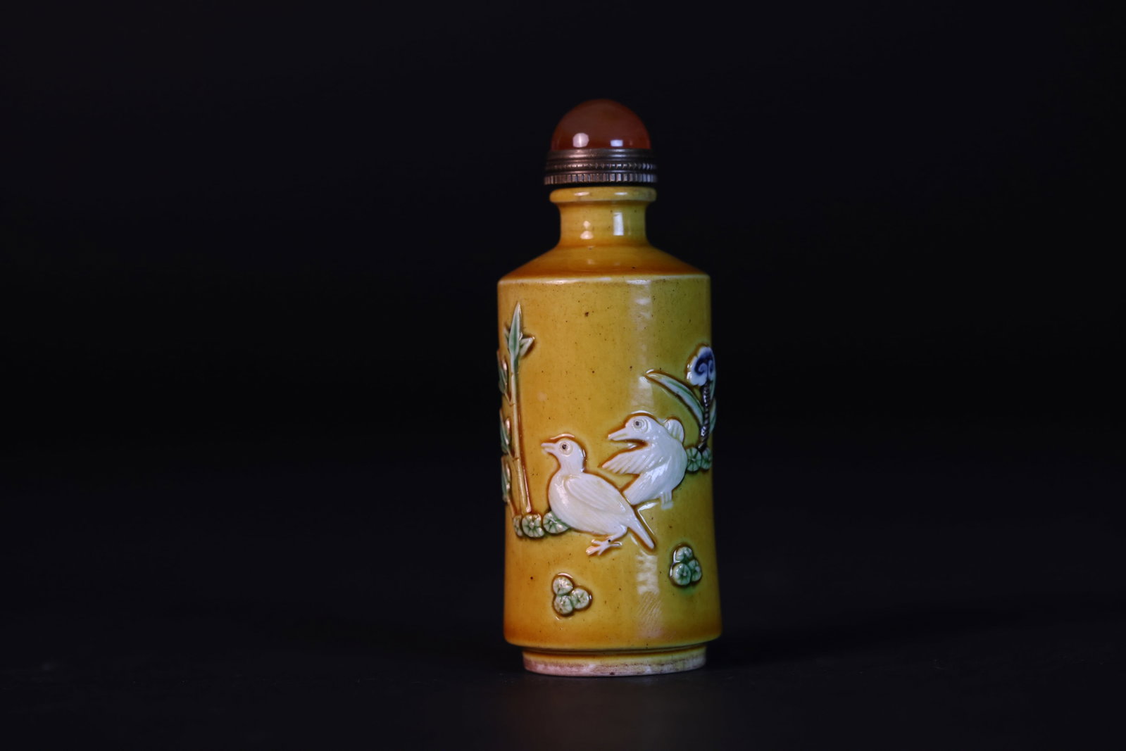 Late Qing yellow-glazed applied floral & bird snuff bottle, 'Chenghua Nianzhi' mark, coral finial: Natural age wear and patina; otherwise in excellent overall condition. H 8cm W 3cm
