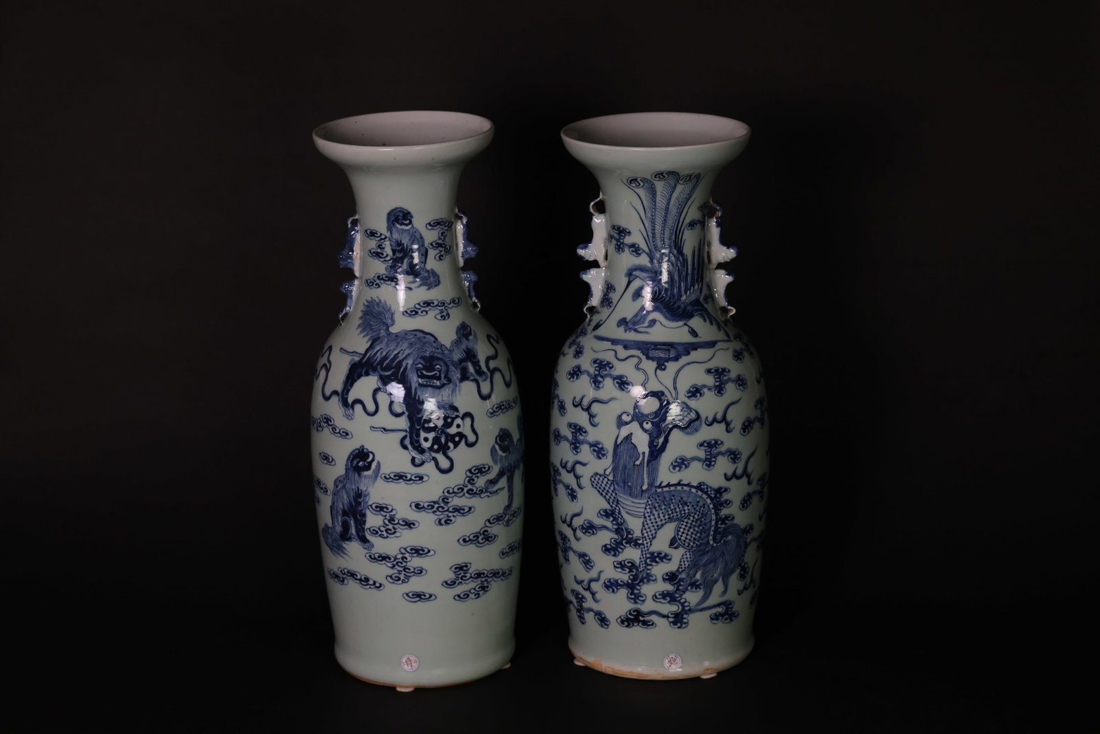Pair of Late Qing douqing blue-white bottles, lion-handles; (1) phoenix & lion; (2) lion & cubs: 1. Naturally aged with signs of use; otherwise in excellent condition. 2. Naturally aged with signs of use; otherwise in excellent condition. 1. H 59cm W 23cm 2. H 59cm W 22cm