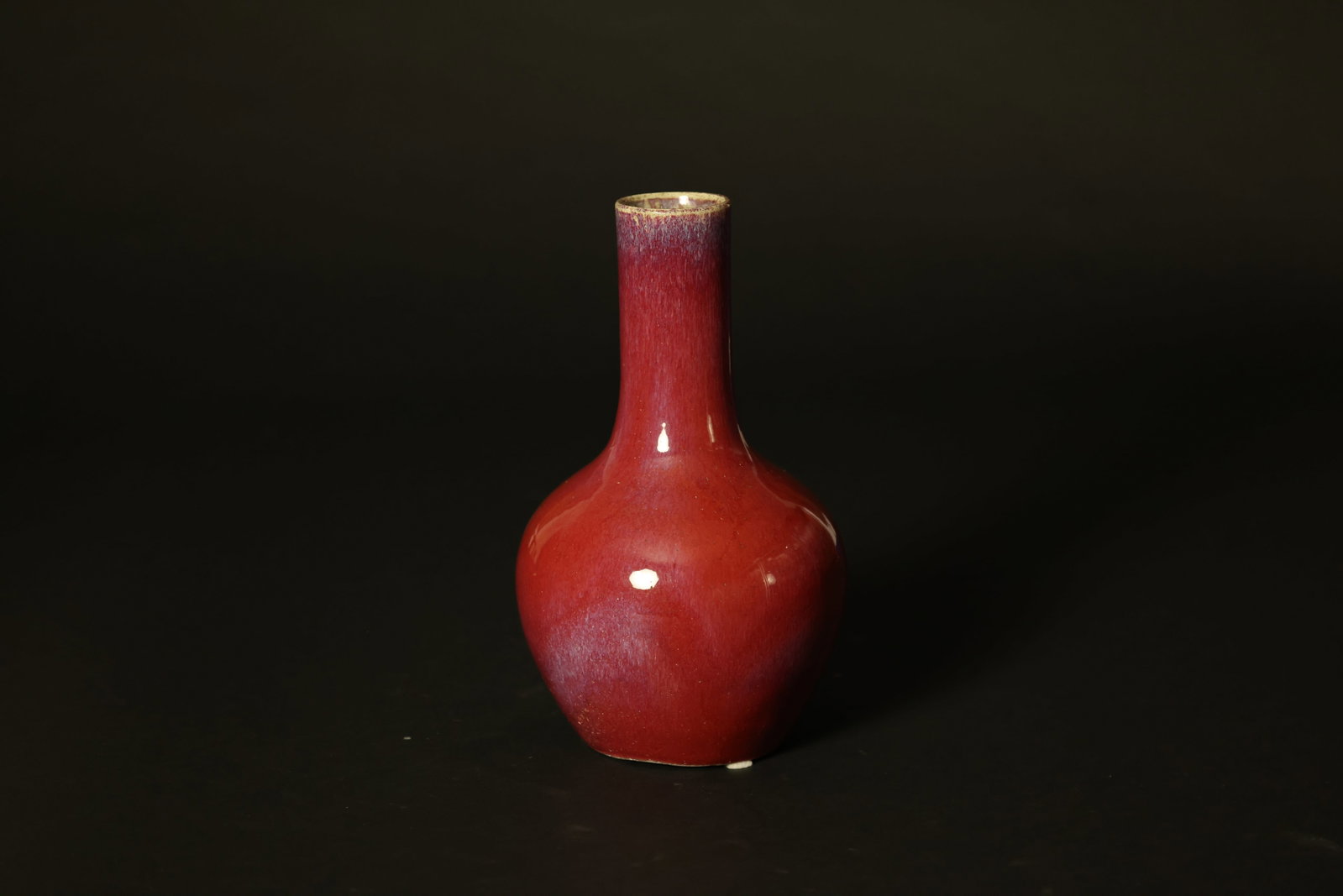 Mid-Late Qing Flambé-Glazed Red and Blue Enamel Tianqiu (Spherical) Bottle: Naturally aged with signs of use; footrim shows traces of manufacture. Otherwise in overall good condition. H 30cm W 16cm