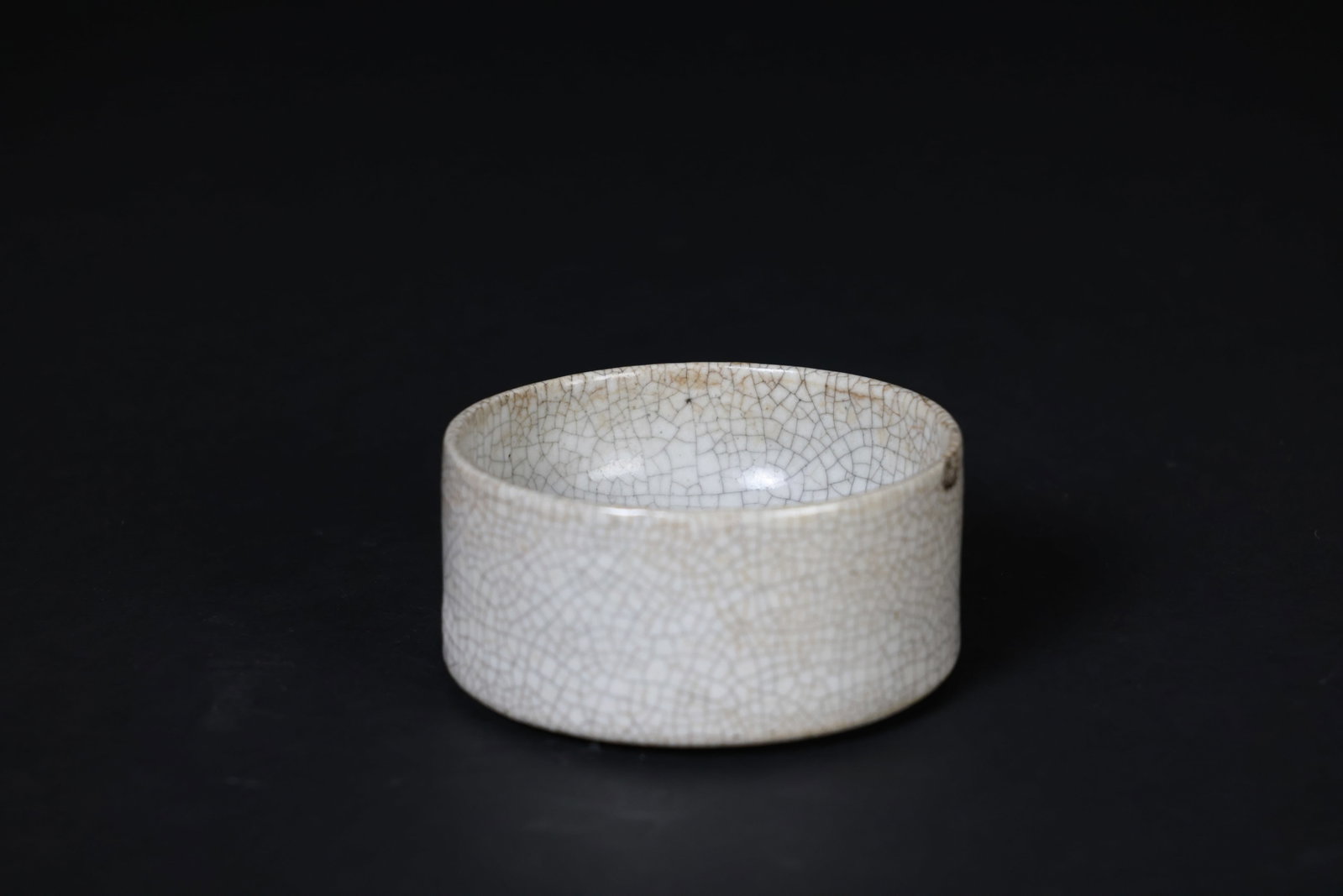 Ming–Qing Period Inkstone in the Style of Ge Ware: Naturally aged patina, with one chip to the rim measuring 1.3 x 0.7 cm; otherwise in overall good condition. H 6.5cm W 12.8cm