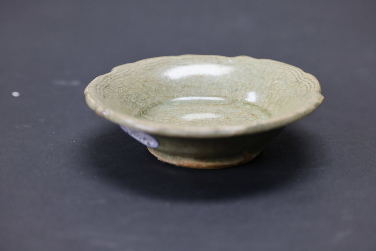 Yuan–Ming Dynasty Longquan Kiln Celadon Small Dish, Incised Border with Floral Rim: Natural age wear and patina; otherwise in excellent overall condition. H 3cm W 11.1cm