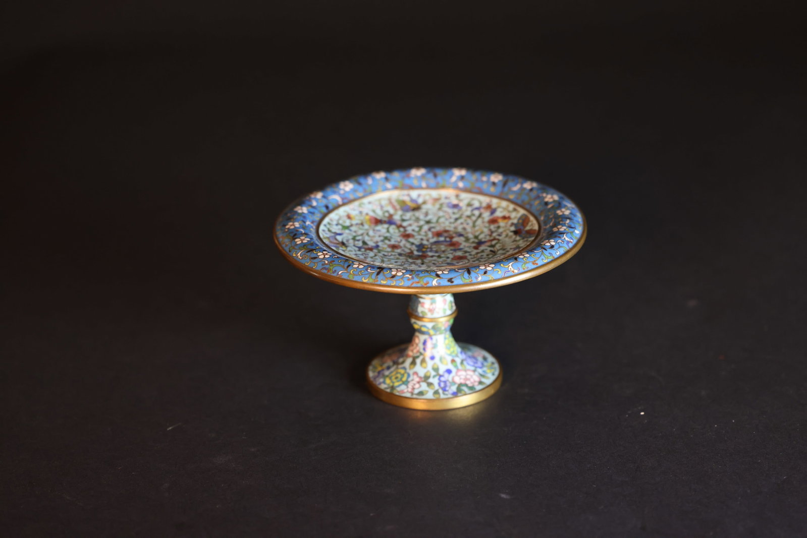 Mid-Qing copper-body cloisonné enamel high-footed offering dish with floral motif: Natural aging and signs of use; otherwise in overall excellent condition. H 9cm W 15.5cm