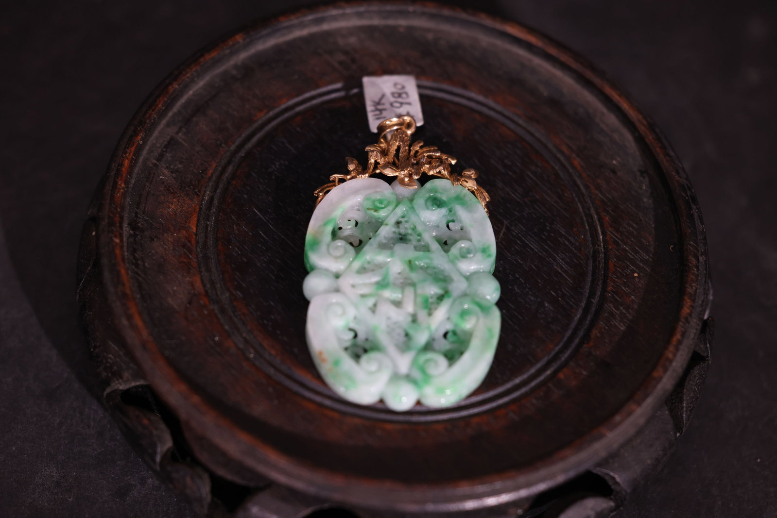14K Gold-Set Jadeite (Floating Green) Openwork Auspicious Pendant: The jadeite is intact with no breaks or losses to the openwork. There are minor natural inclusions in the stone. The 14K gold mount is secure with no signs of damage or repair. Weight 27g